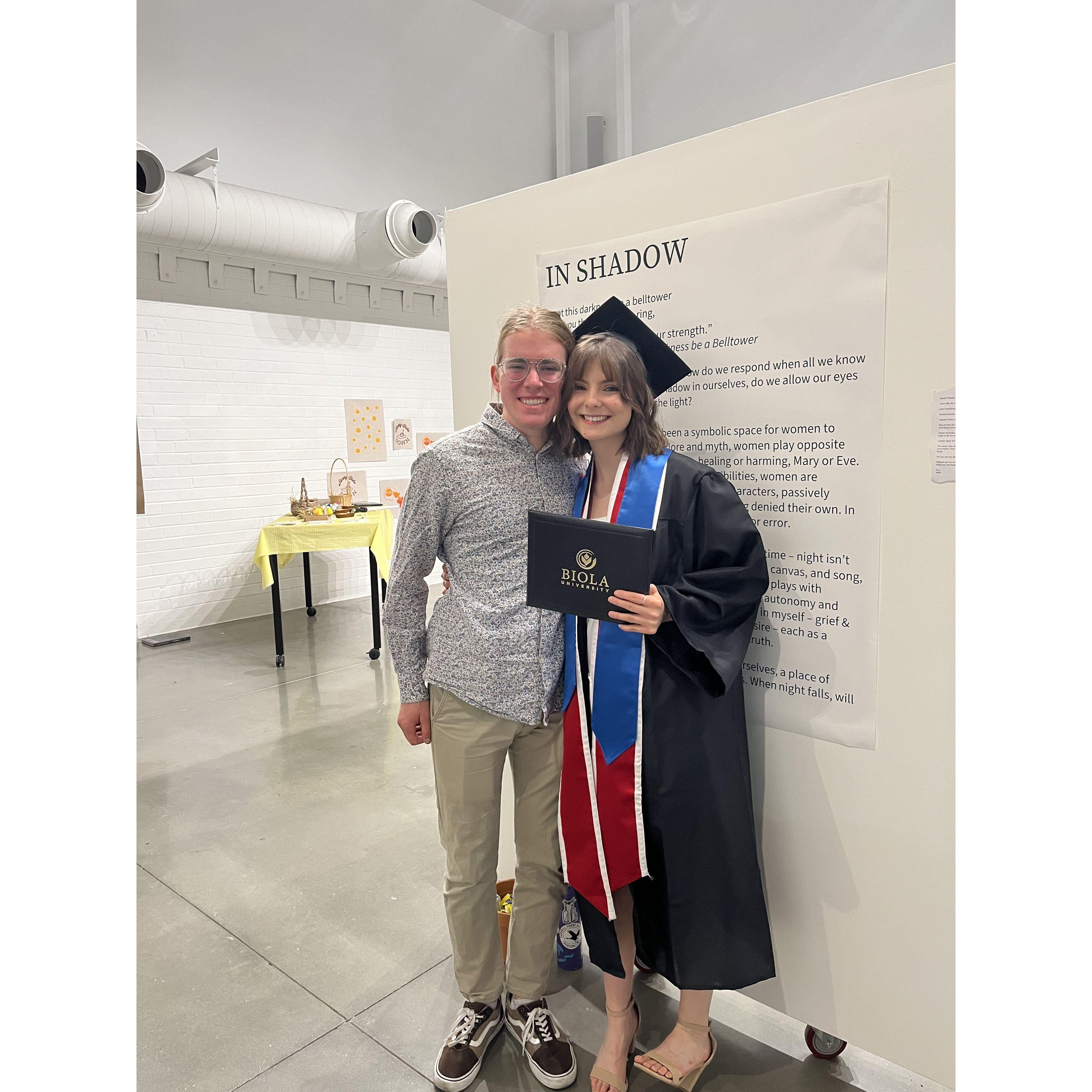 At Molly's graduation, in front of her show statement for "In Shadow"