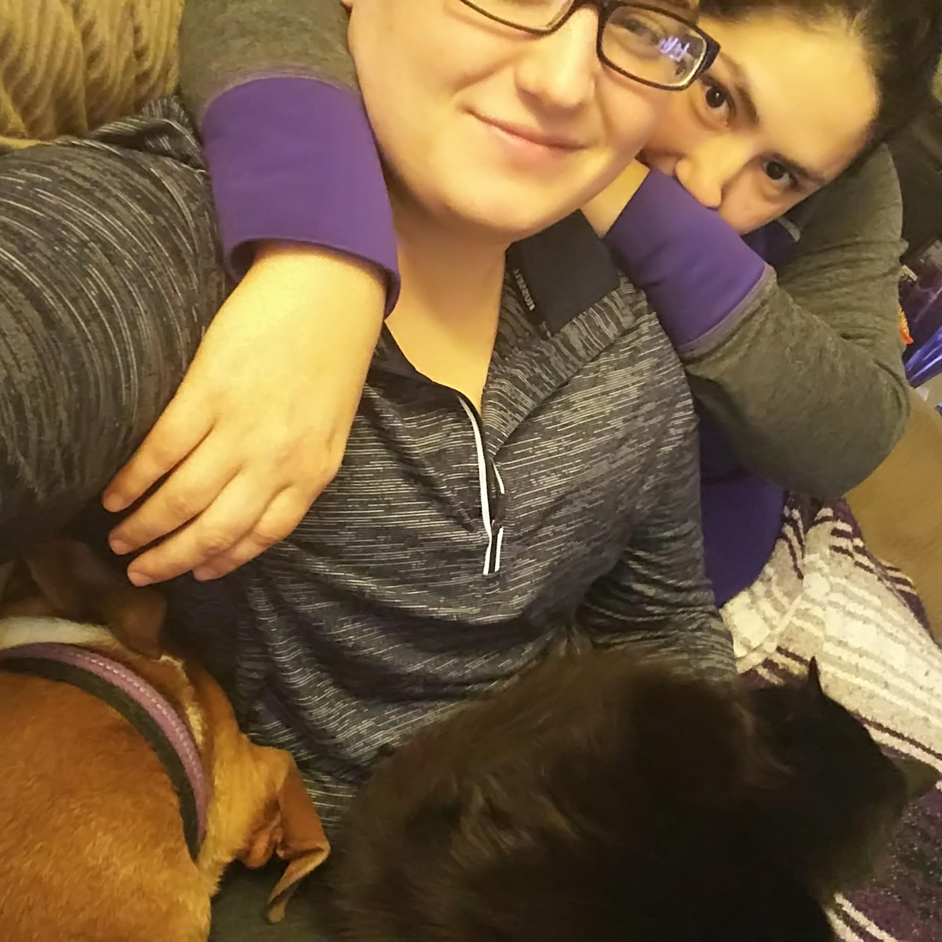Just our average day of cuddles on the couch. p.s. the dog is hiding her nose from the evil cat.