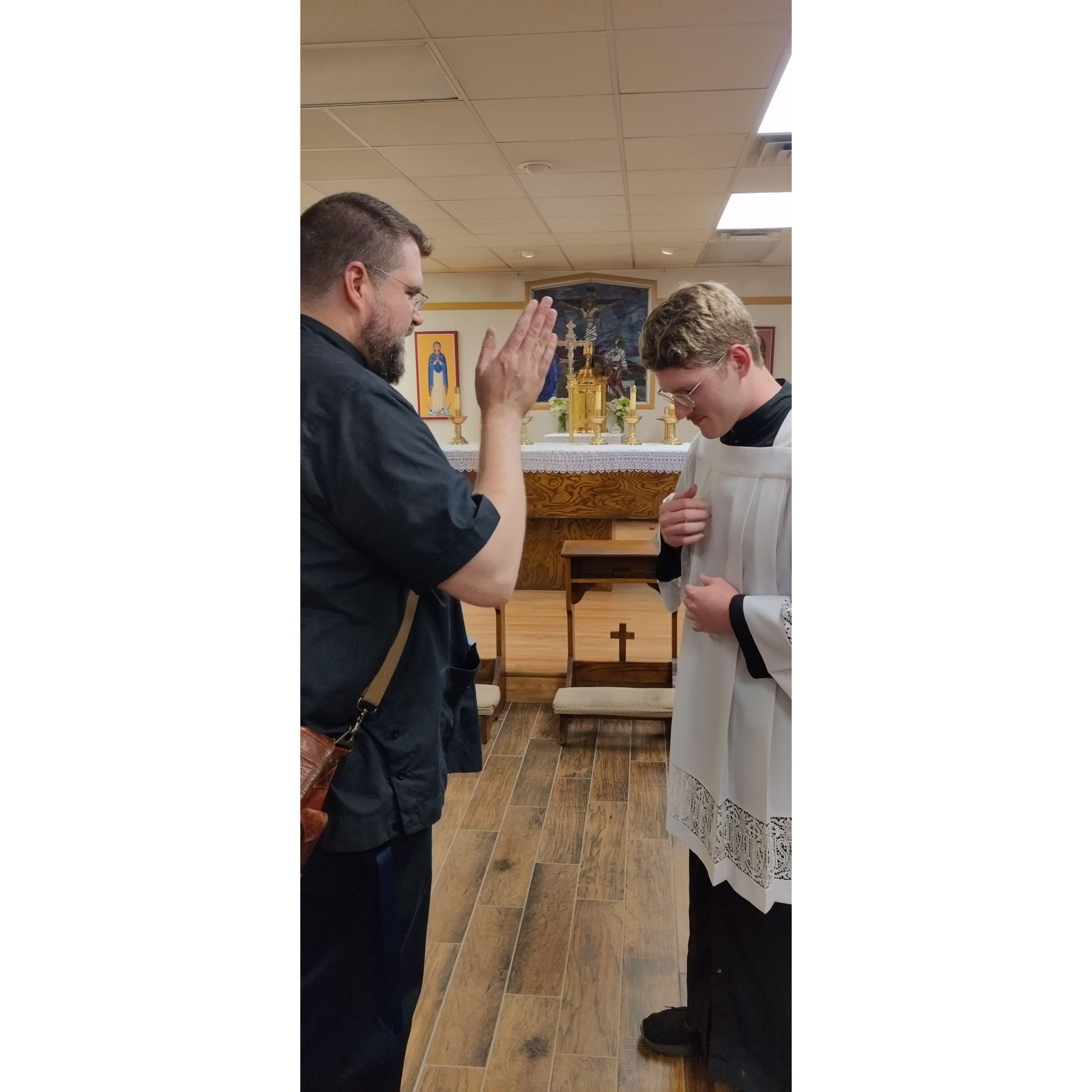 David receiving birthday blessing from Fr. Matthew