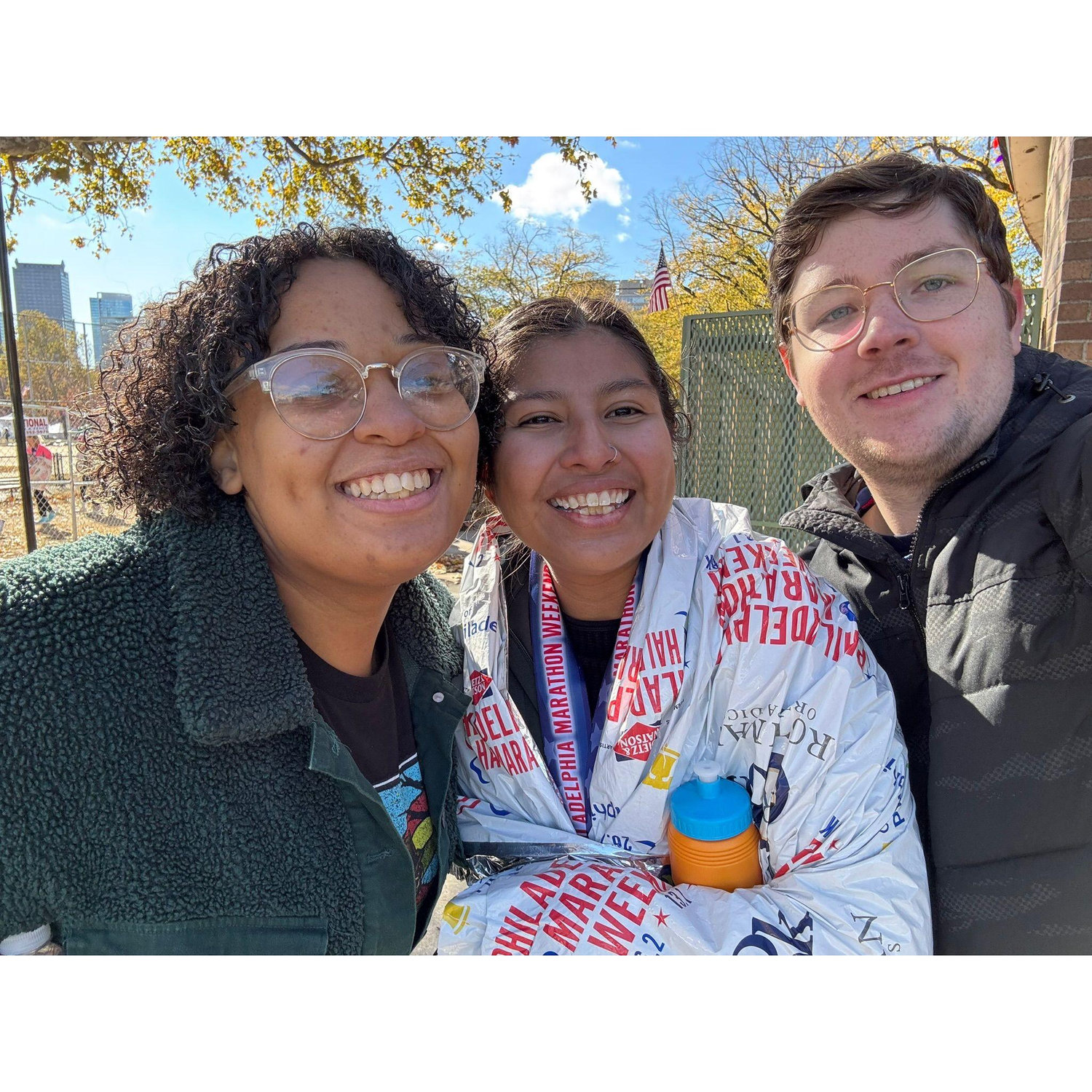 Ana finishing her first half marathon, celebrating with Fred and Anaiah.