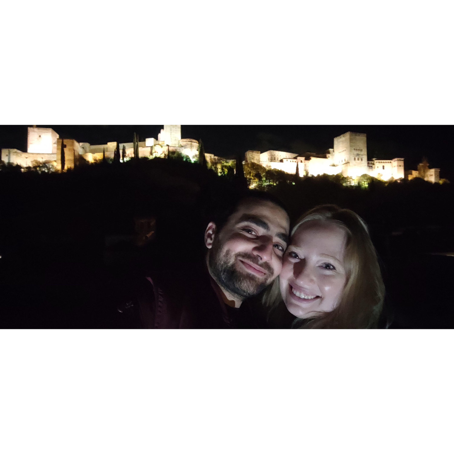 In front of La Alhambra in Granada, Spain. A dream of Genna's to visit, and Mostafa read the walls filled with Arabic to her.