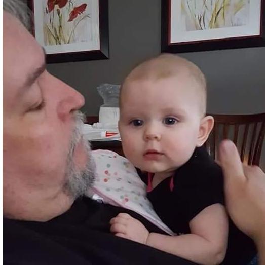 Wayne watching Lily while I cook dinner....She loves to hear him sing....