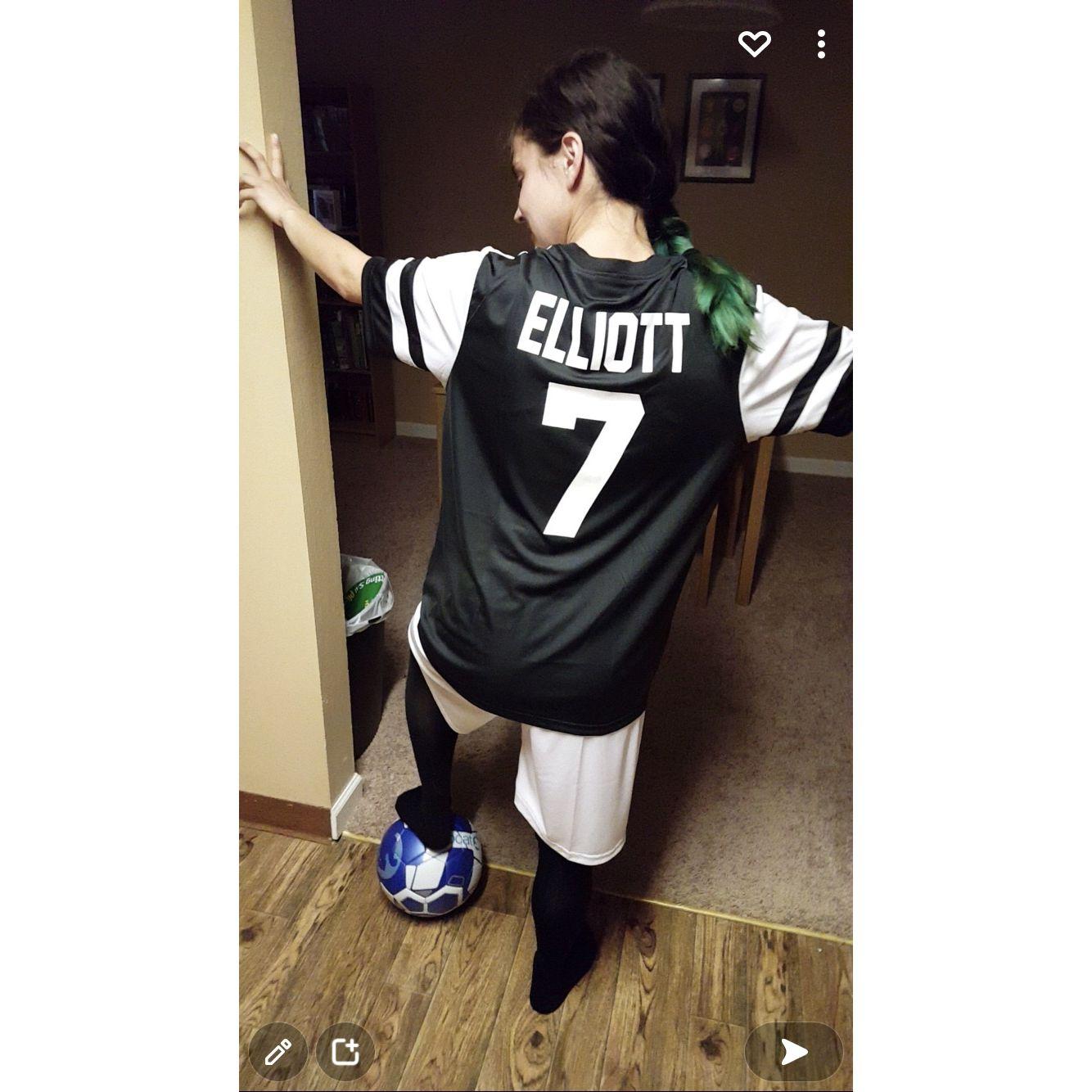 Wearing Izaak’s soccer jersey.