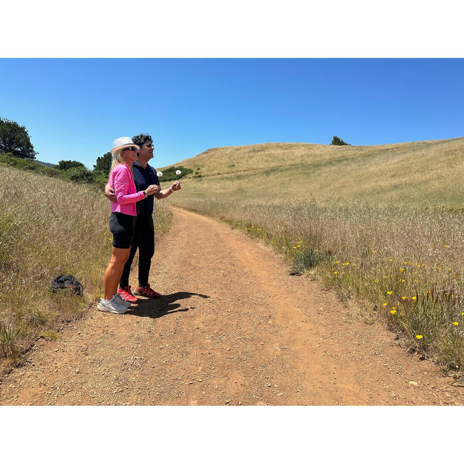 A woman on a bike saw us standing with our dandelions and she stopped to take a picture! One of my favorites.