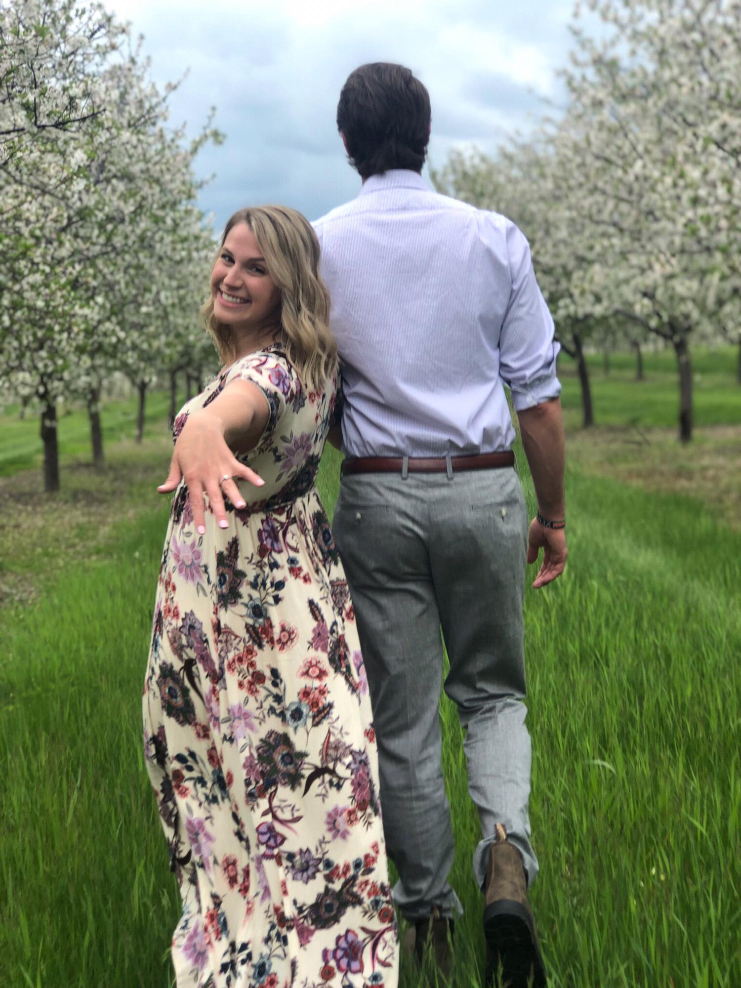 Engaged in Traverse City, MI walking among the cherry blossoms! Photo credit: Devon Burke