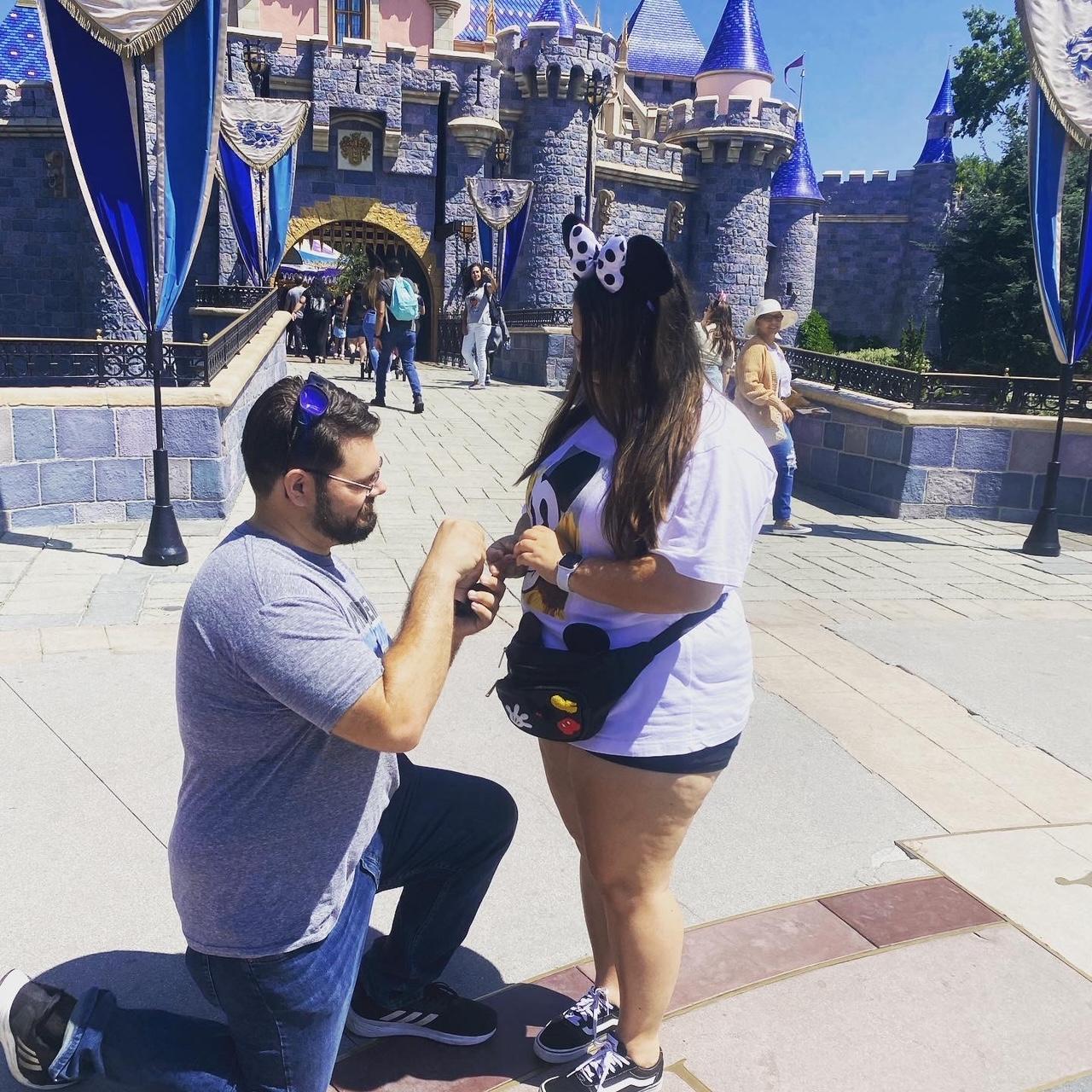 He proposed right in front of the Disney Castle!