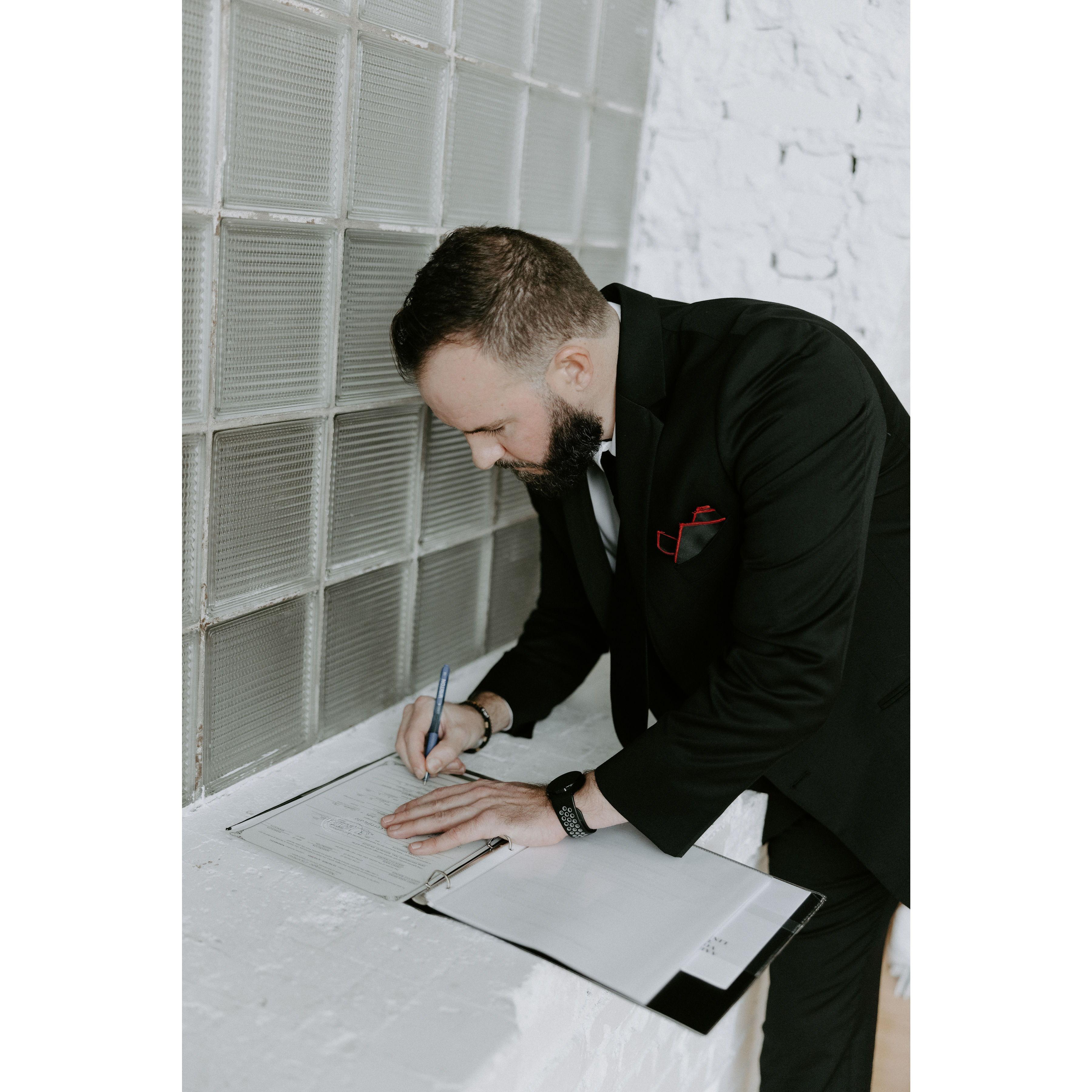 Corey signing the marriage license