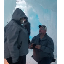 Dillion Ice castles, a man on his knee in the cold, while G & P take pics and video.