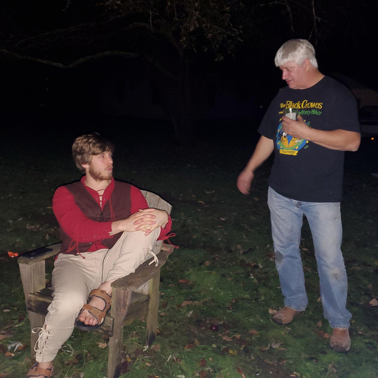 David and Paige's Dad by the fire at a Halloween party.