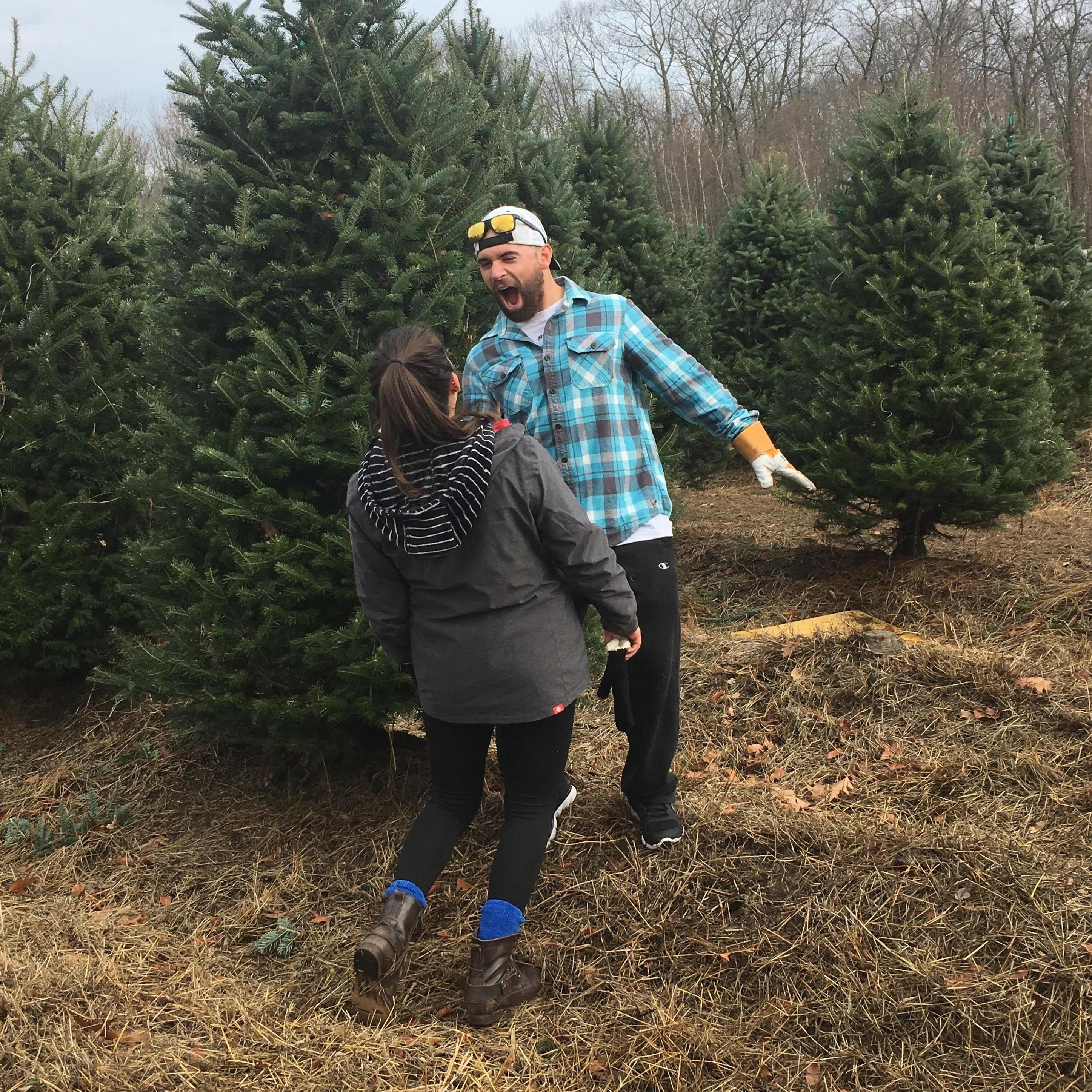 Our attempt at 'being cute' after cutting down our first Christmas tree together.