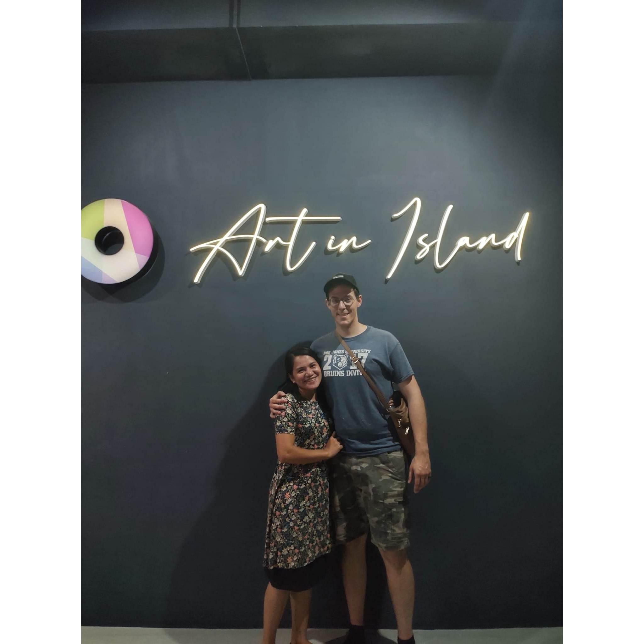 Here we are at "Art In Island" for our extended anniversary date. We asked a stranger who was in front to take picture of us.