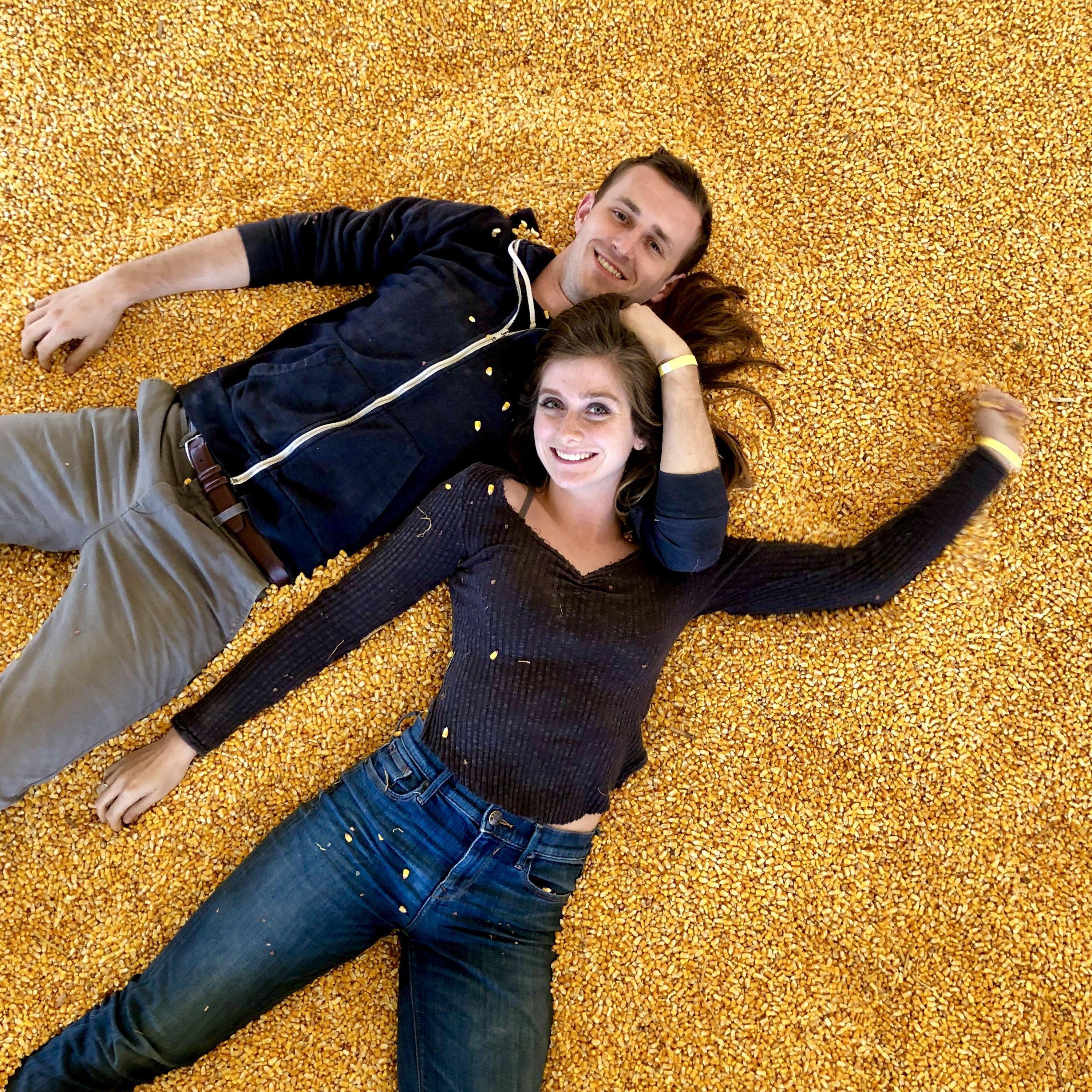 Emily and Joe content in their natural Midwest habitat: A giant pile of corn.