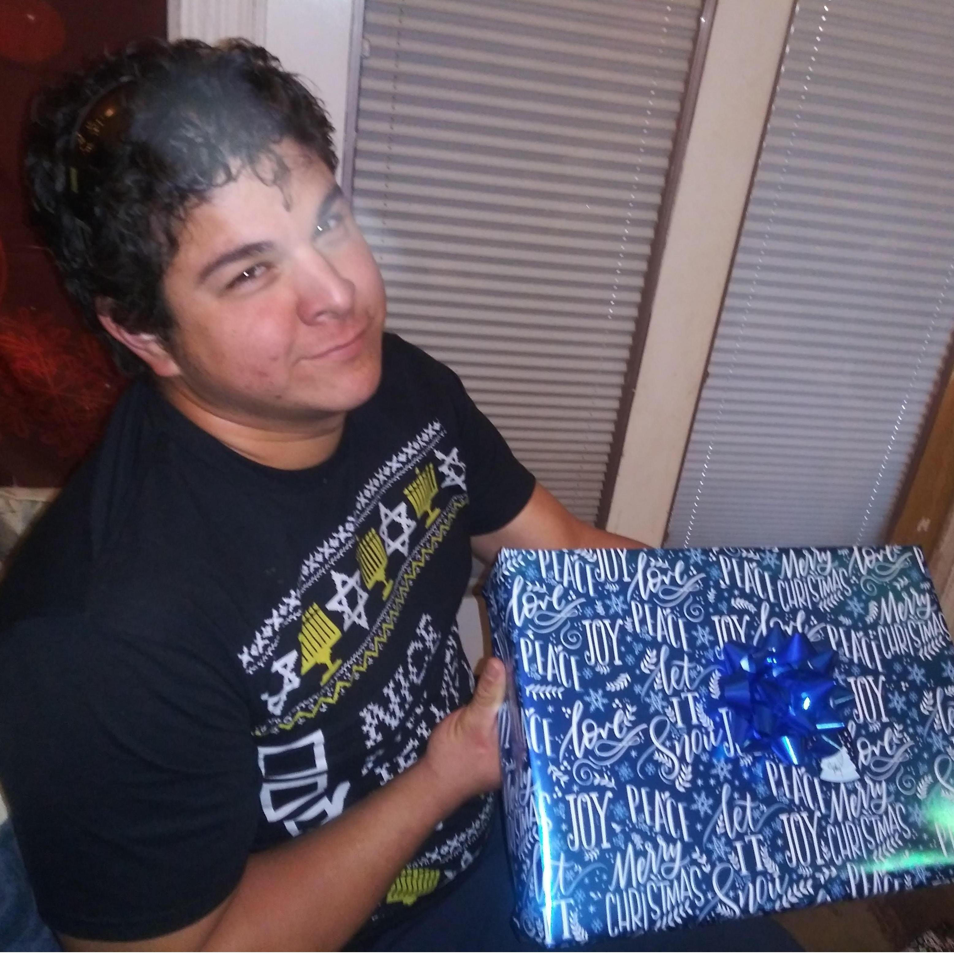 Jubal displeased by Terri's demand for more holiday present pictures.
