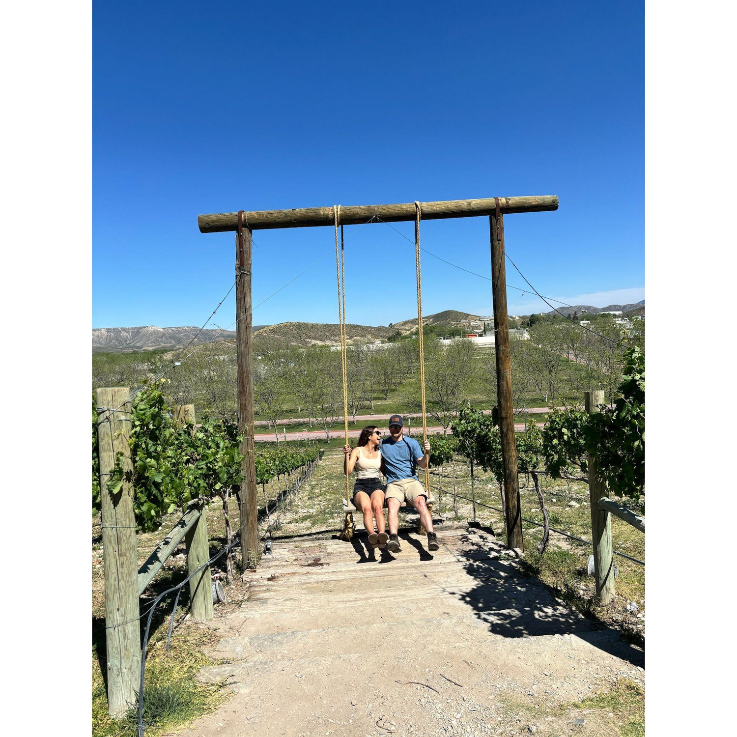 Paola and Ryan having a blast in the swing.