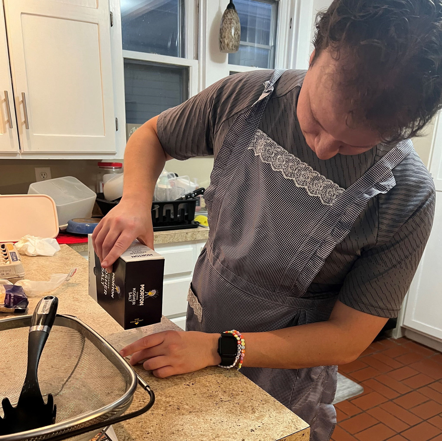 Daniel learning to cook from best man J.E.B.