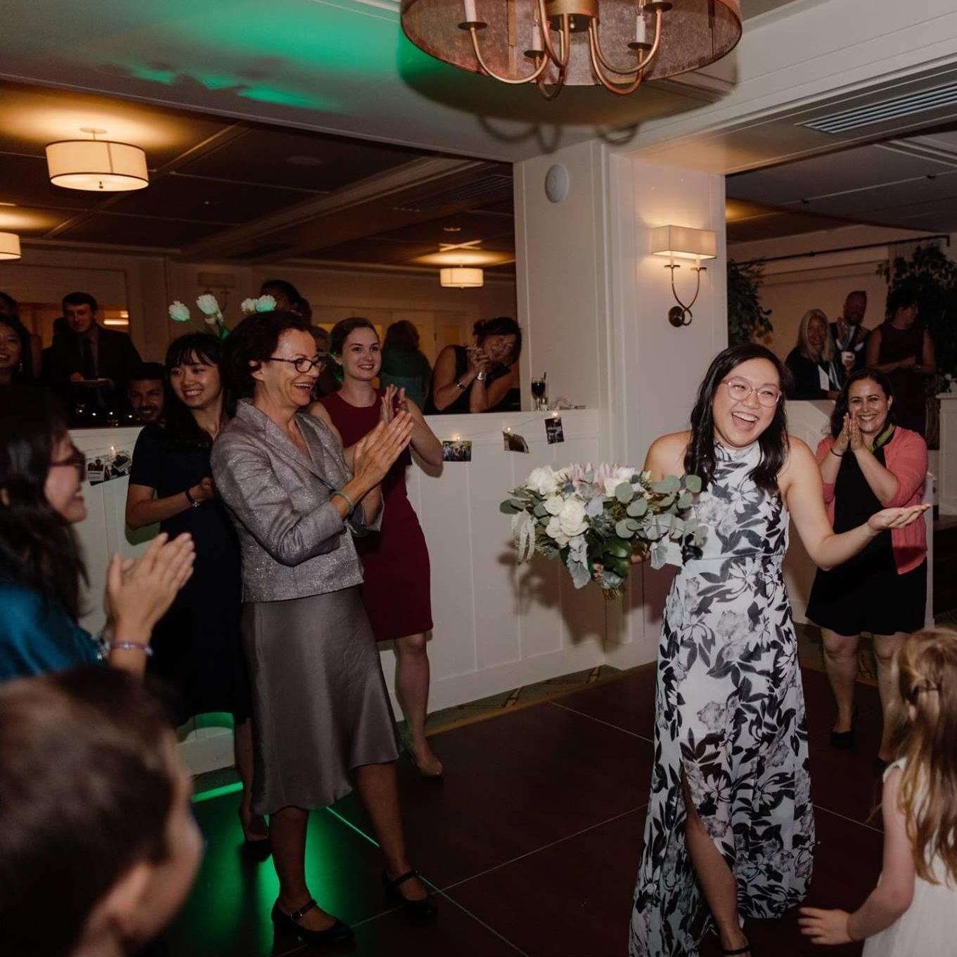 Nhi caught the bouquet at Thuy's wedding! Nathan meanwhile was eating cake in the corner. (August 2018 - Portland, Maine)