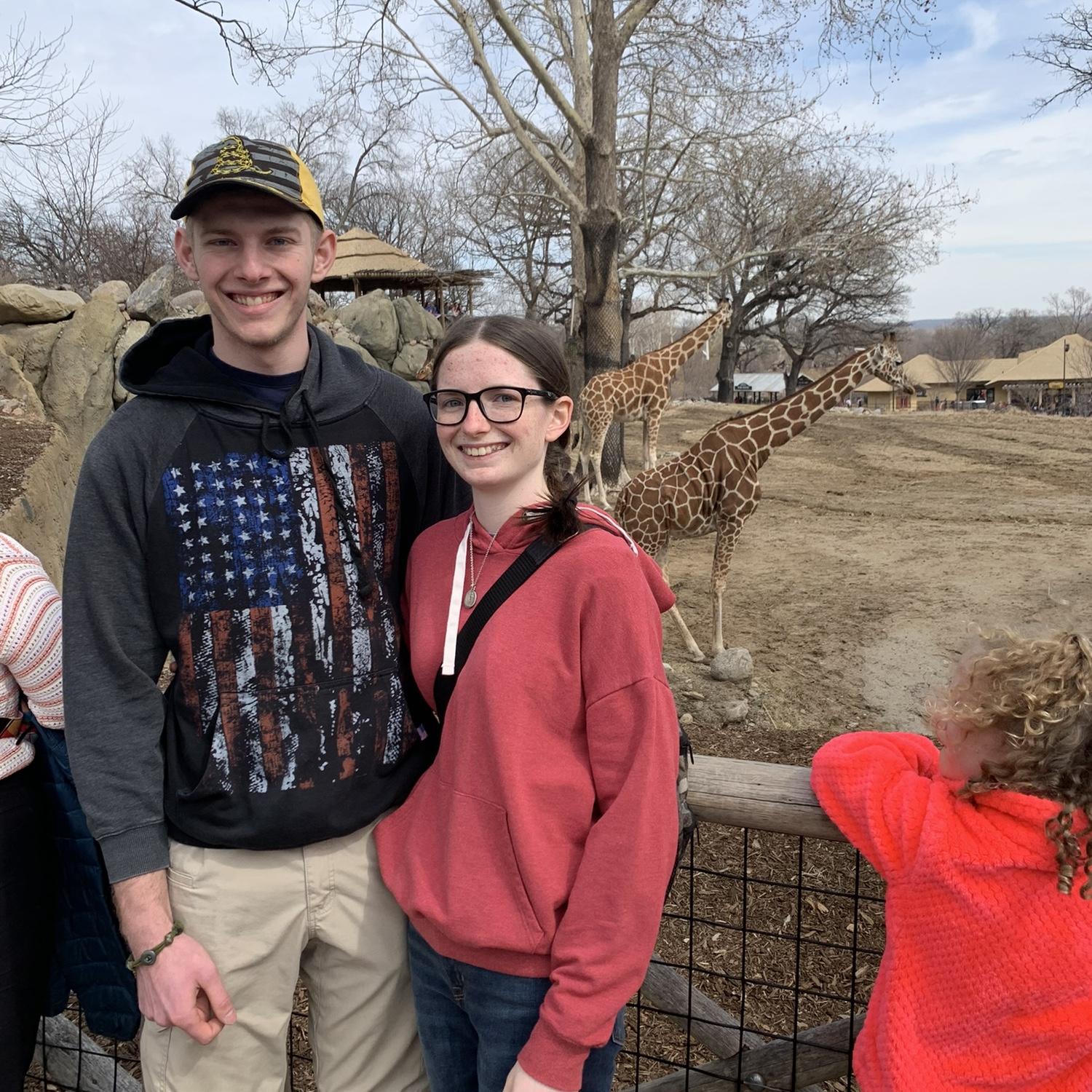March 2023 - Lauren's first time at the Omaha zoo, taking a picture with her favorite person and favorite animal!