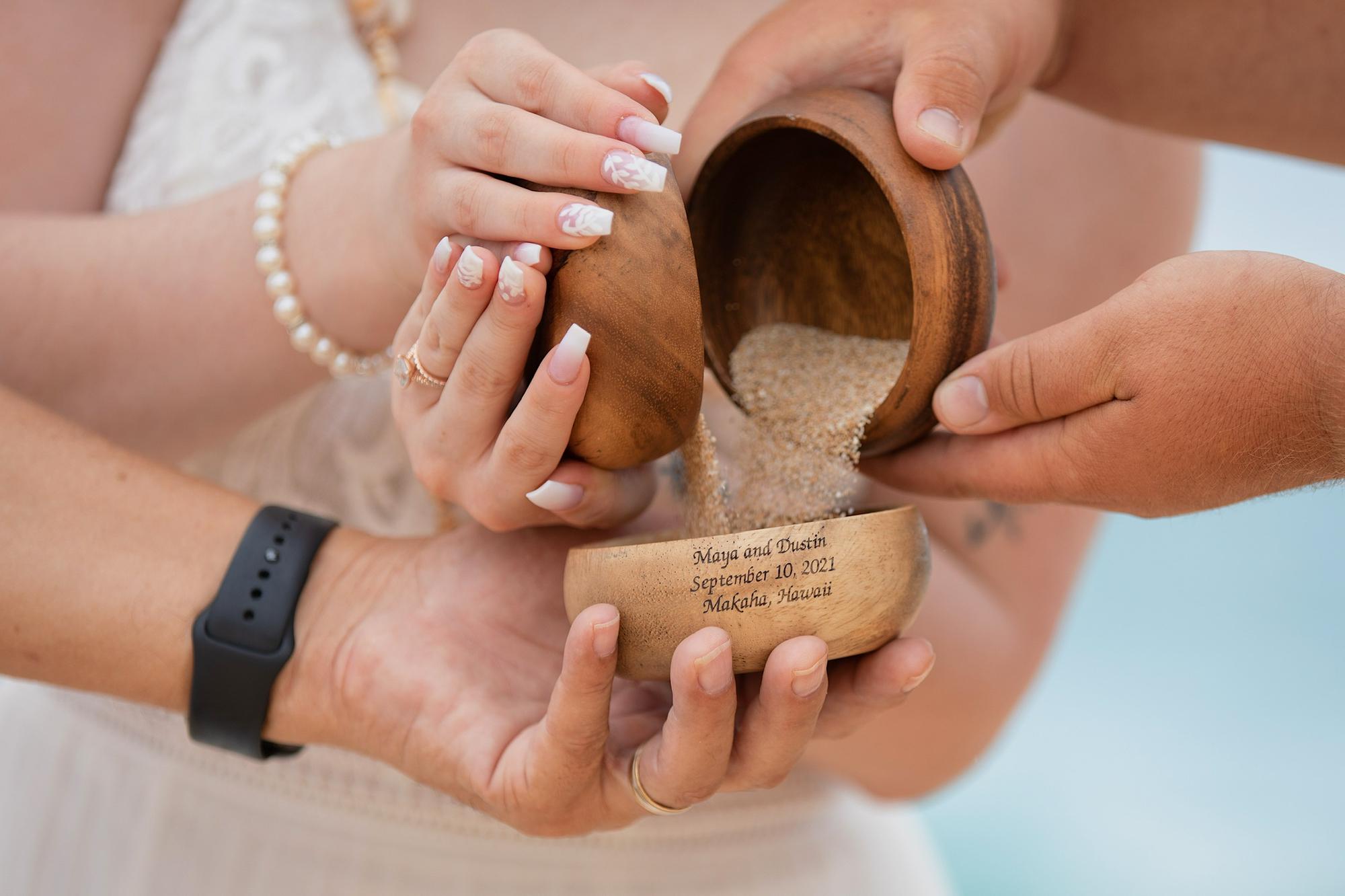 Dustin and Maya performing the sand ceremony at their wedding 2021