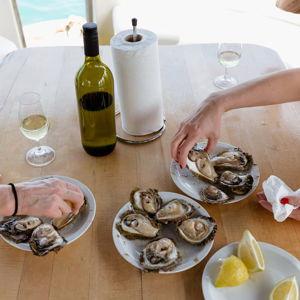 Fresh oyster and wine tasting aboard small boat off the coast of Dubrovnik, Croatia
