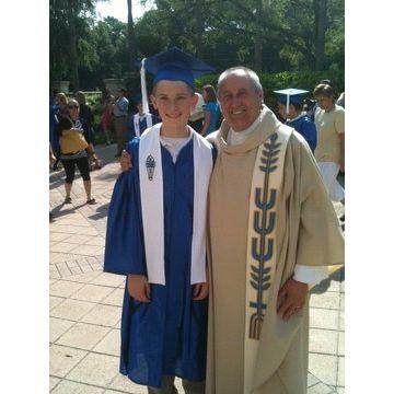 Brennan's 8th grade graduation with Father Mark