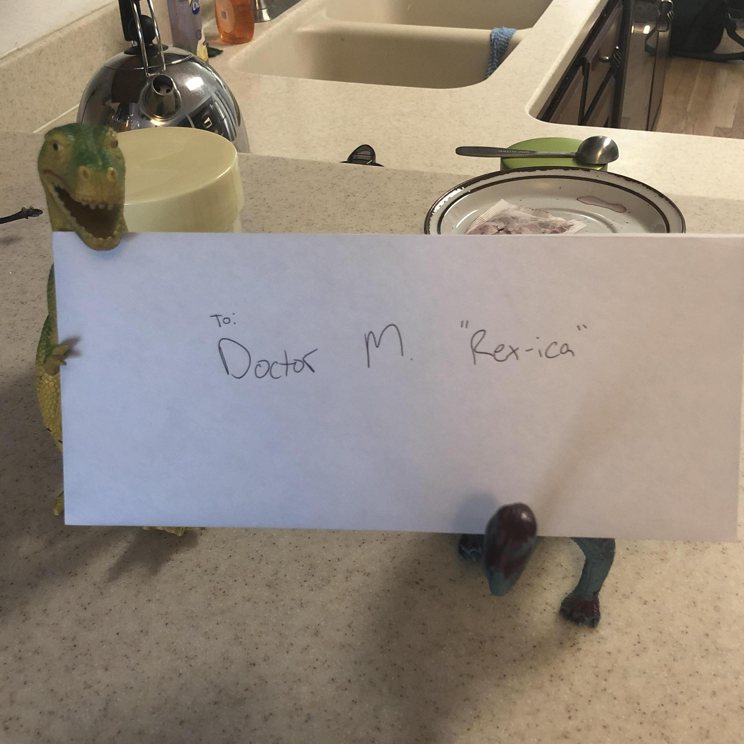 KC sent Monica on a dino themed scavenger hunt to propose. This was the first clue, left on her doorstep. Both toy dinosaurs came from KC's childhood!