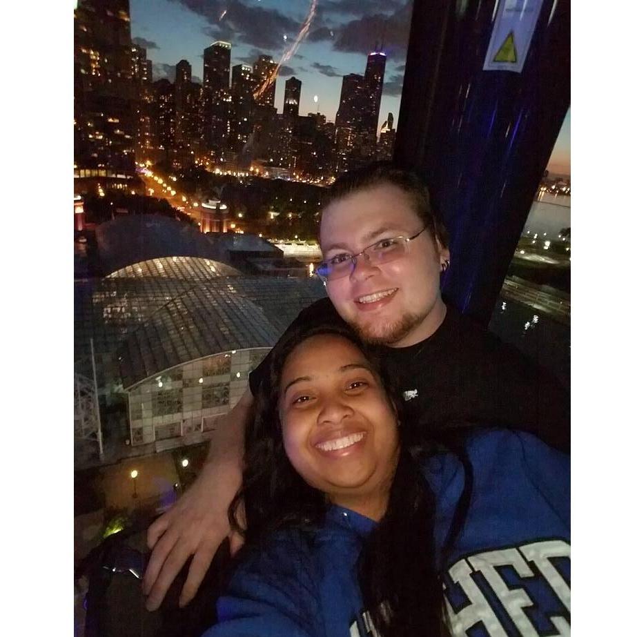 Enjoying a night out in Chicago in a Ferris Wheel overlooking the beautiful cityscape.