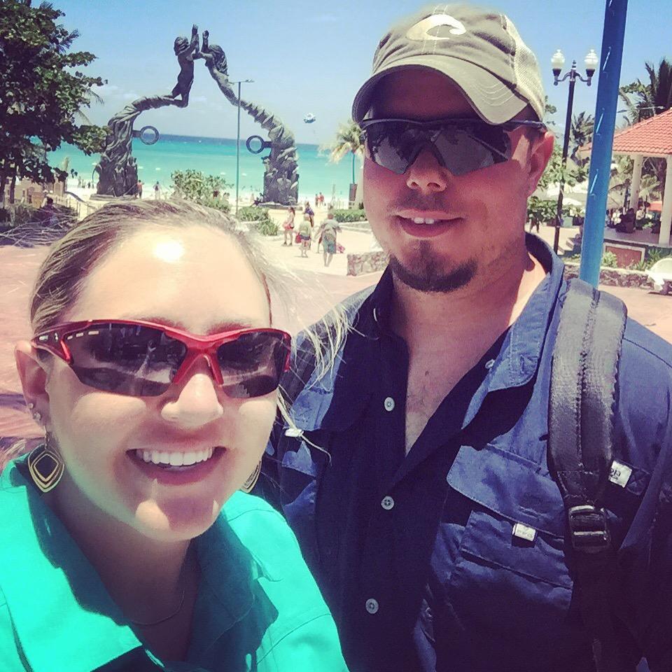 Standing in front of the "Mayan Gateway" statue at the main public beach in Playa del Carmen.