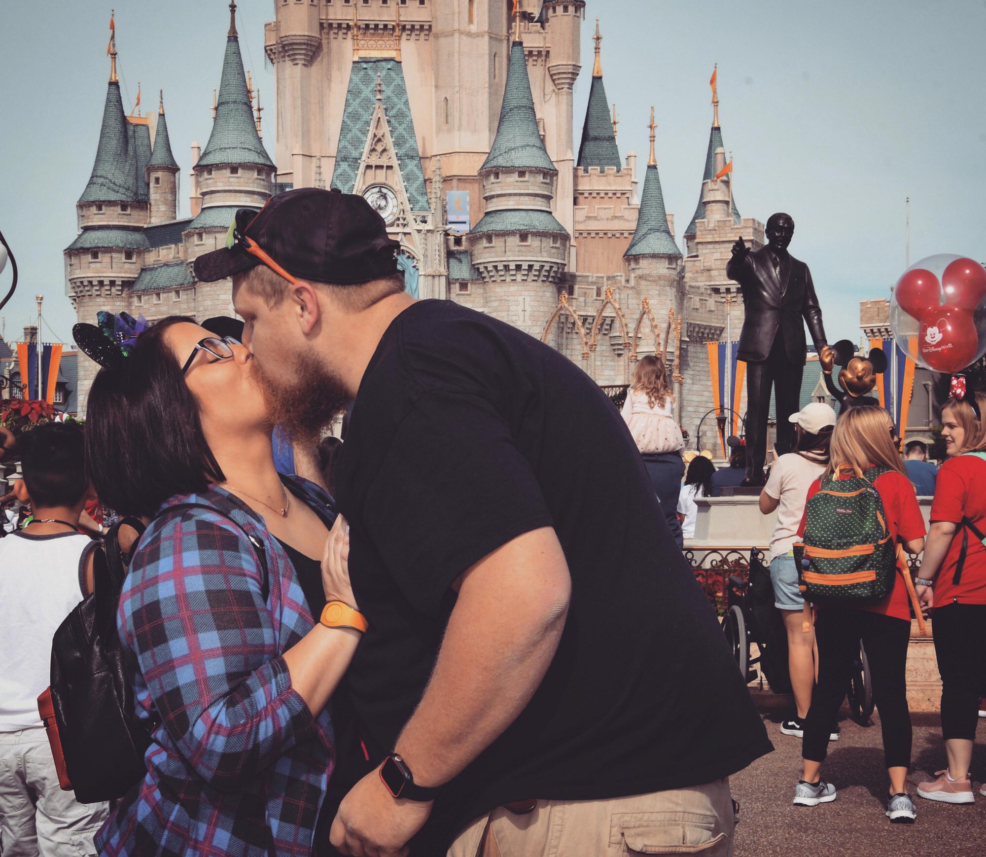 Our first kiss as an engaged couple in front of Cinderella's castle!