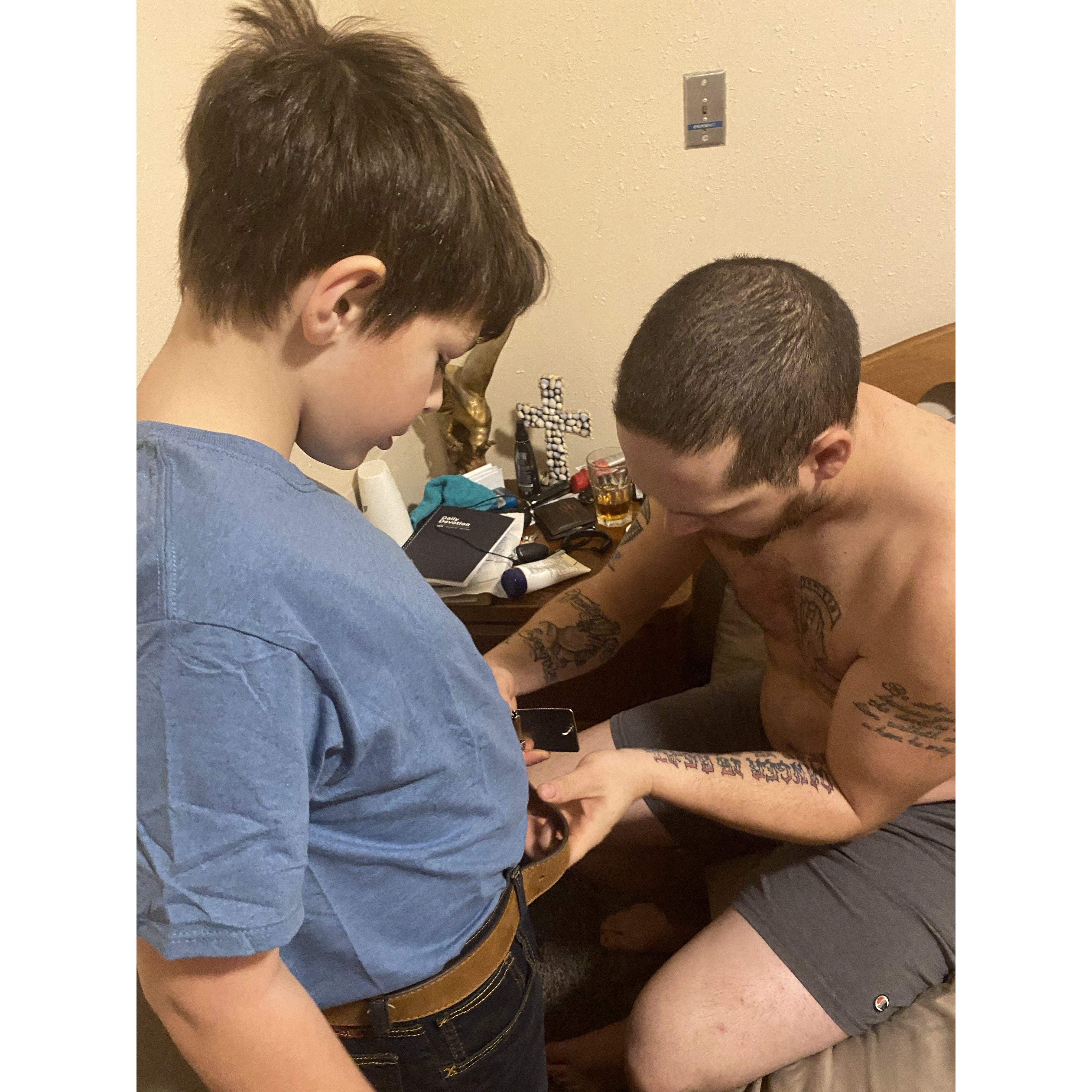 Aaron helping David with his belt