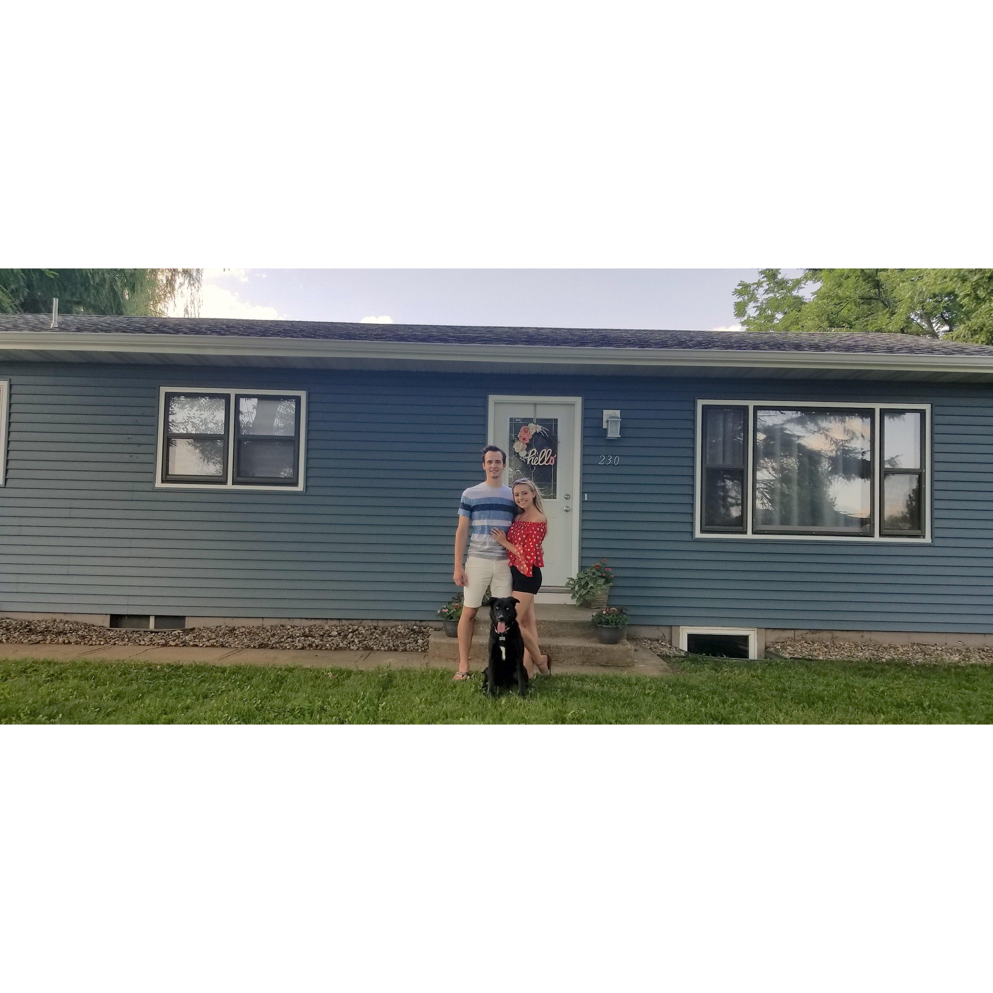 Kyle, Marley and Ellie in front of the home they bought in Tea.
