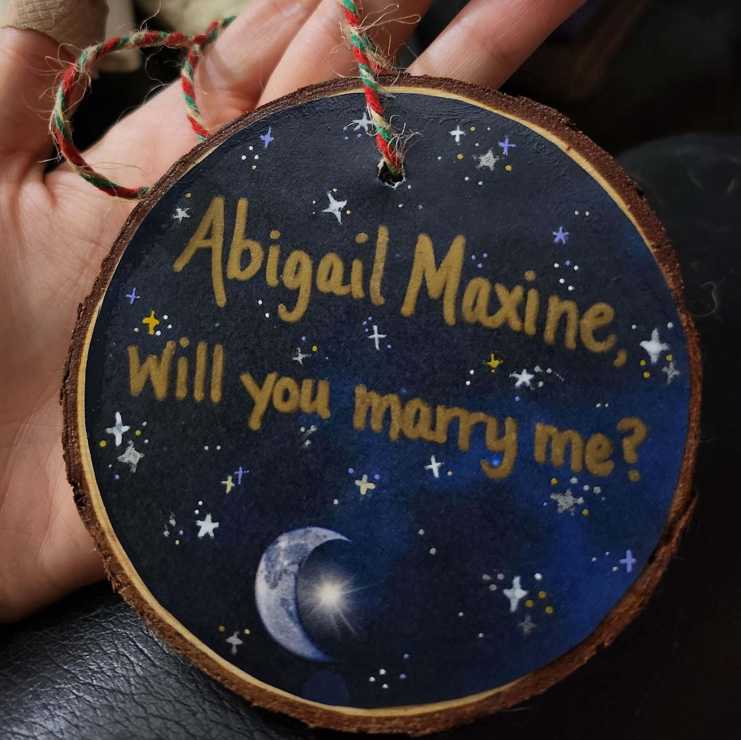(Side 2) Hannah proposed with an ornament. Hannah & Abby make homemade ornaments every year so the proposal was special to them.
