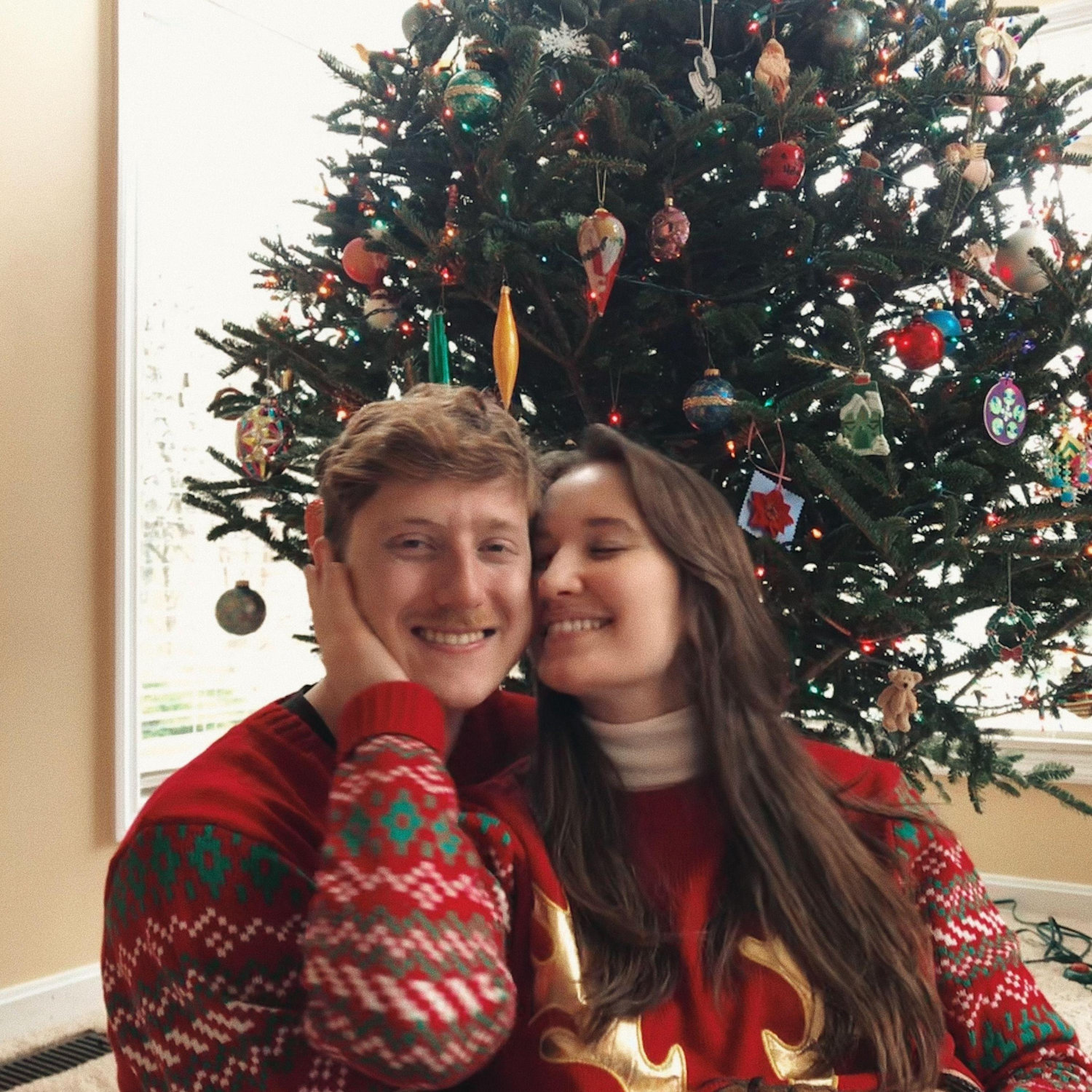 December 2020: Our first Christmas together - outfitted with matching sweaters, naturally!