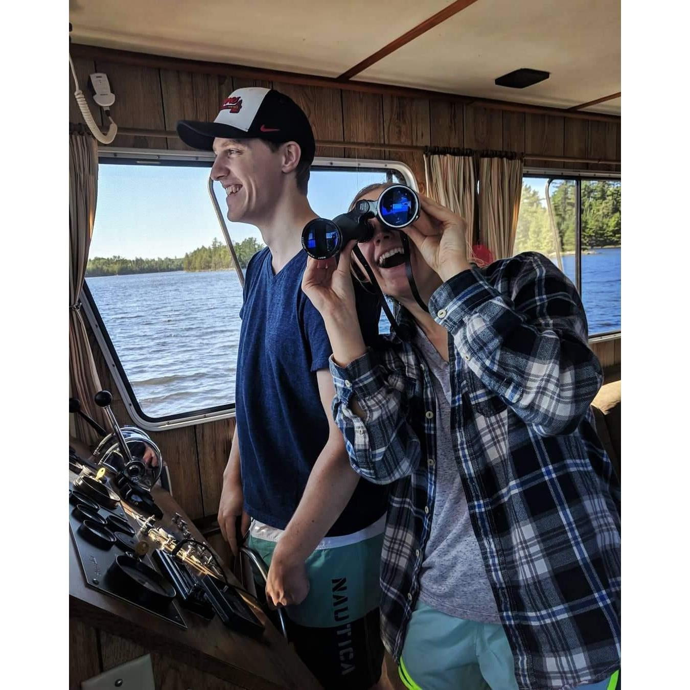 On a house boat vacation in Minnesota with Allison's family. Evan became the permanent driver for the crew and returned everyone to shore safely.