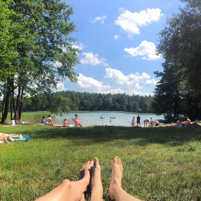 Here we are chillin' at a lake while travelling in Poland in Summer 2017. We were engaged during this trip, in Krakow, Poland.