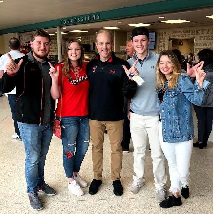 Zach, Haylee, Adam, and Marisa watching Tech basketball in Tulsa and meeting Matt Wells! (Tech Football Coach)