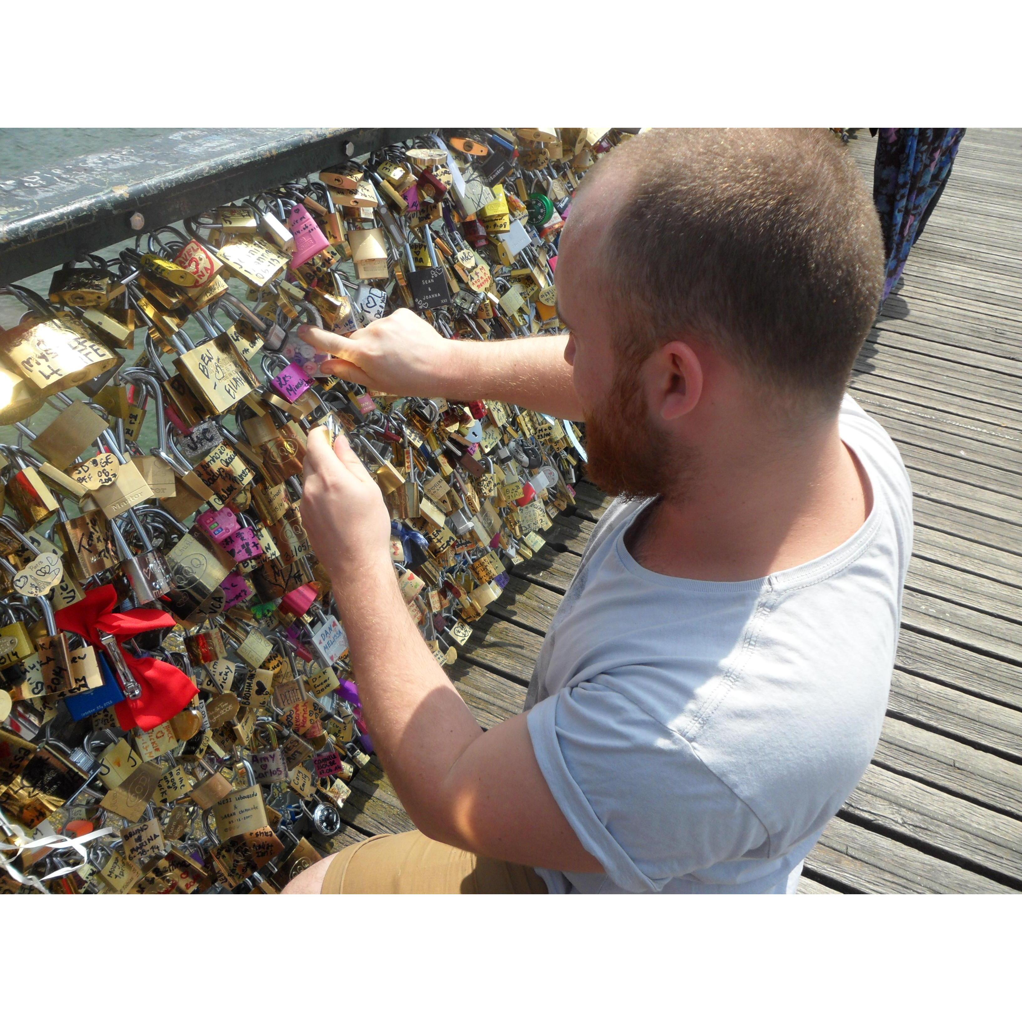 Adding our lock to the Pont des Arts in Paris