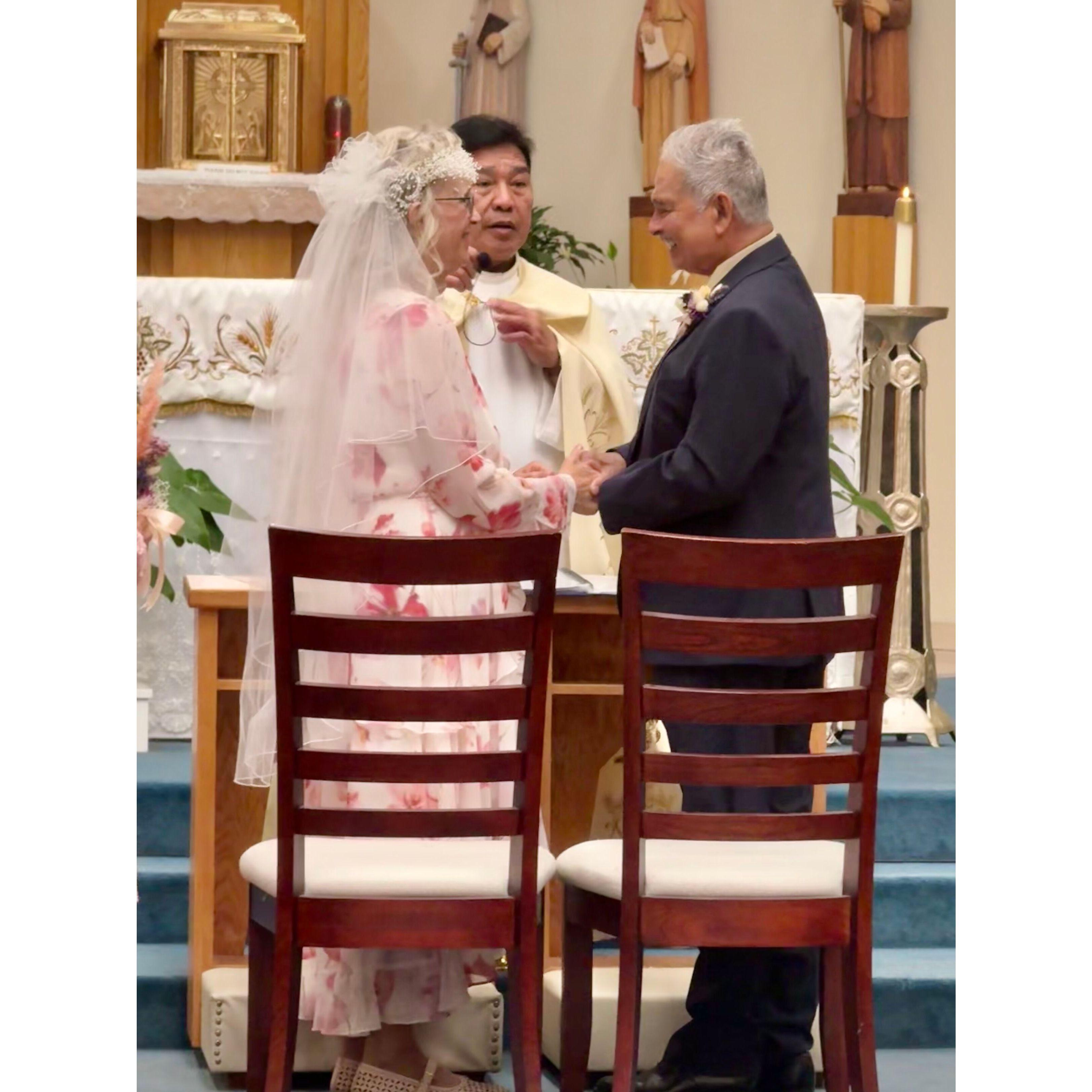 Father Abundo leads the Bride and Groom through the ceremony.