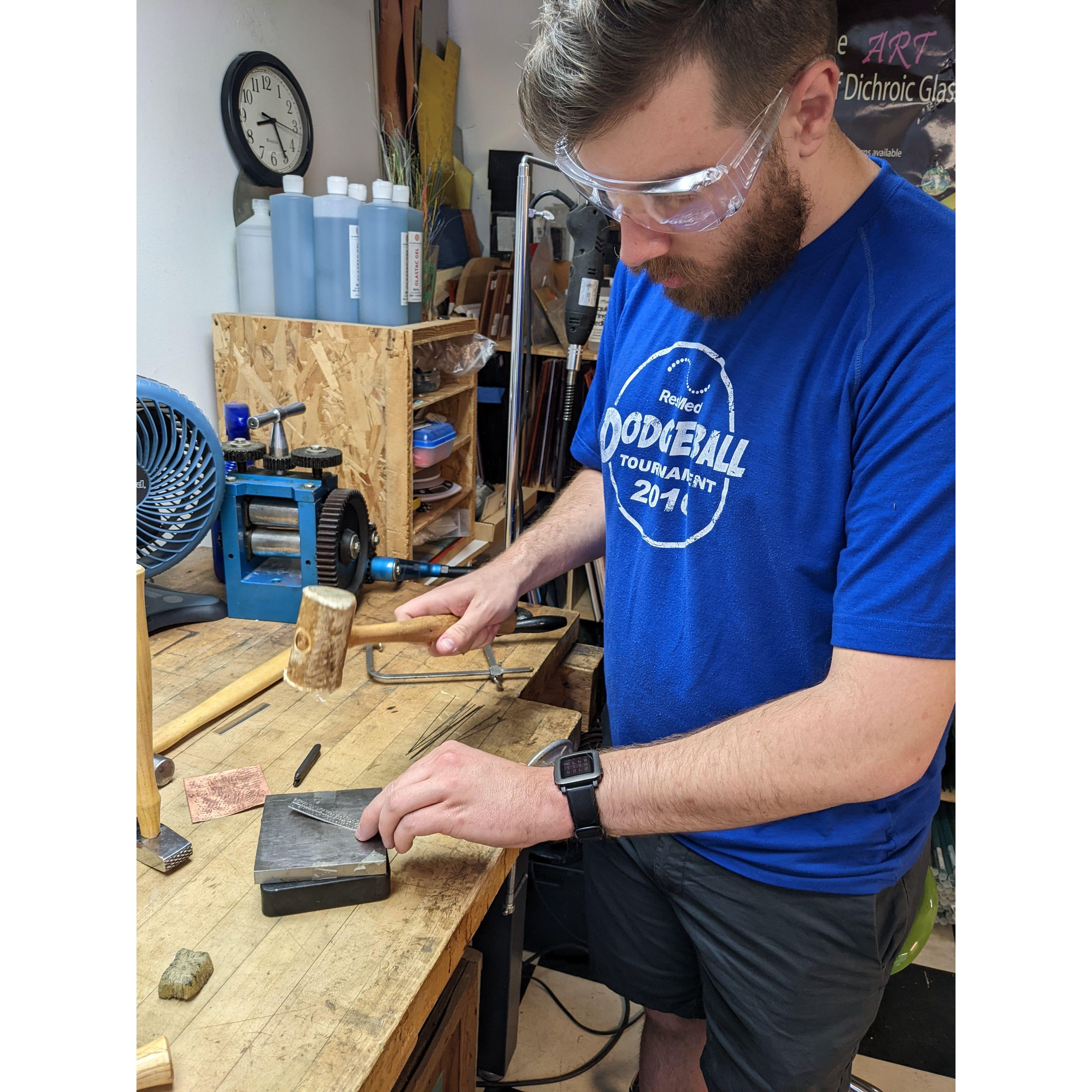 Trying a new skill-making rings together! Her e is Clay working on his design.