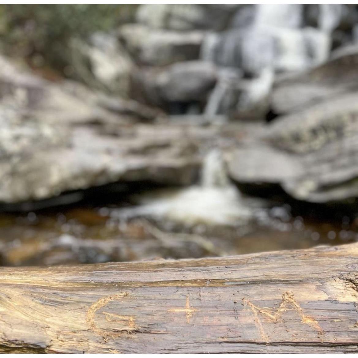 Gabriel hiked off the path and climbed down below to the bottom of the waterfall to engrave our initials in the tree right in front and taste the fresh waterfall water. A memory to last forever.