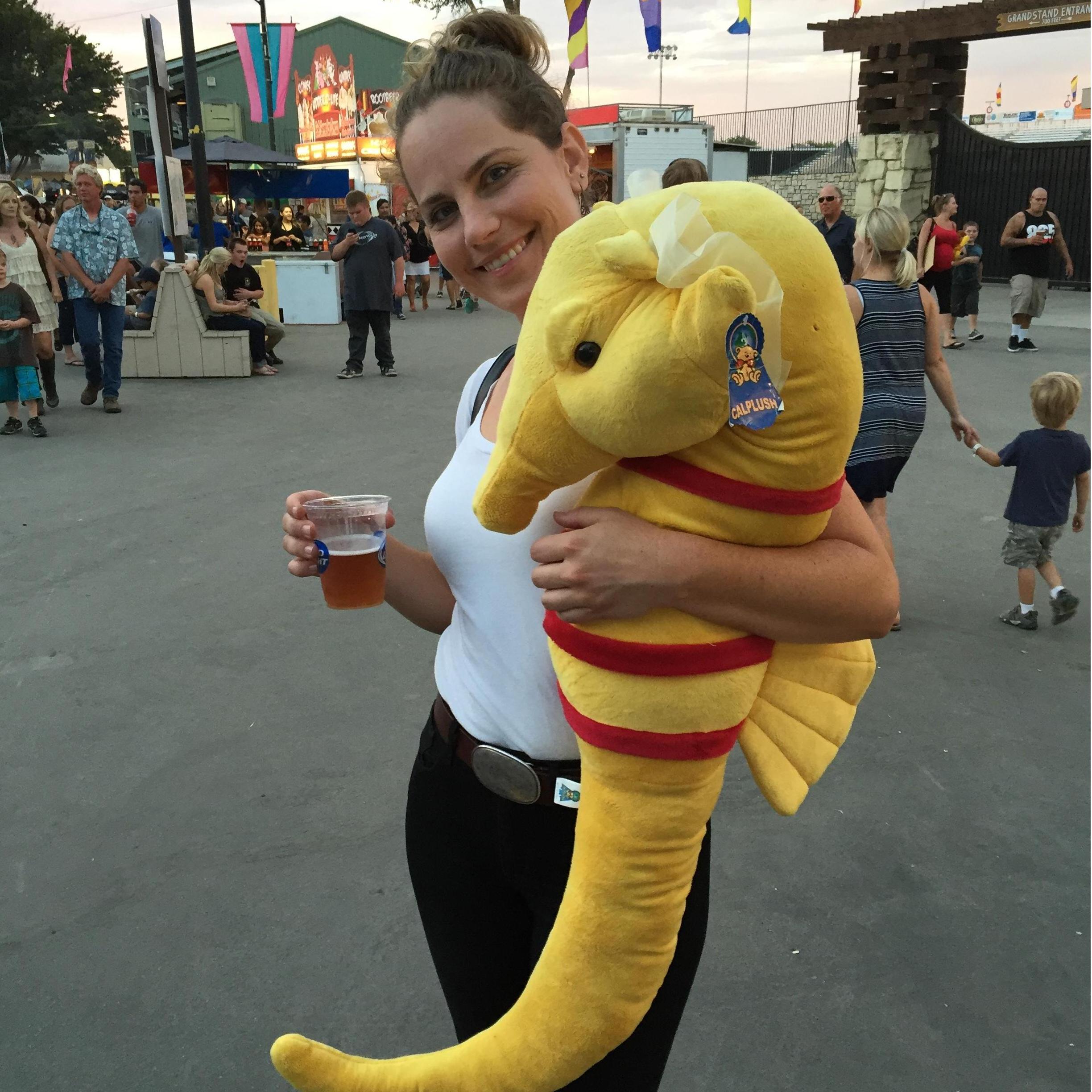 Snuggling with the prize that Ben won during a fair game.