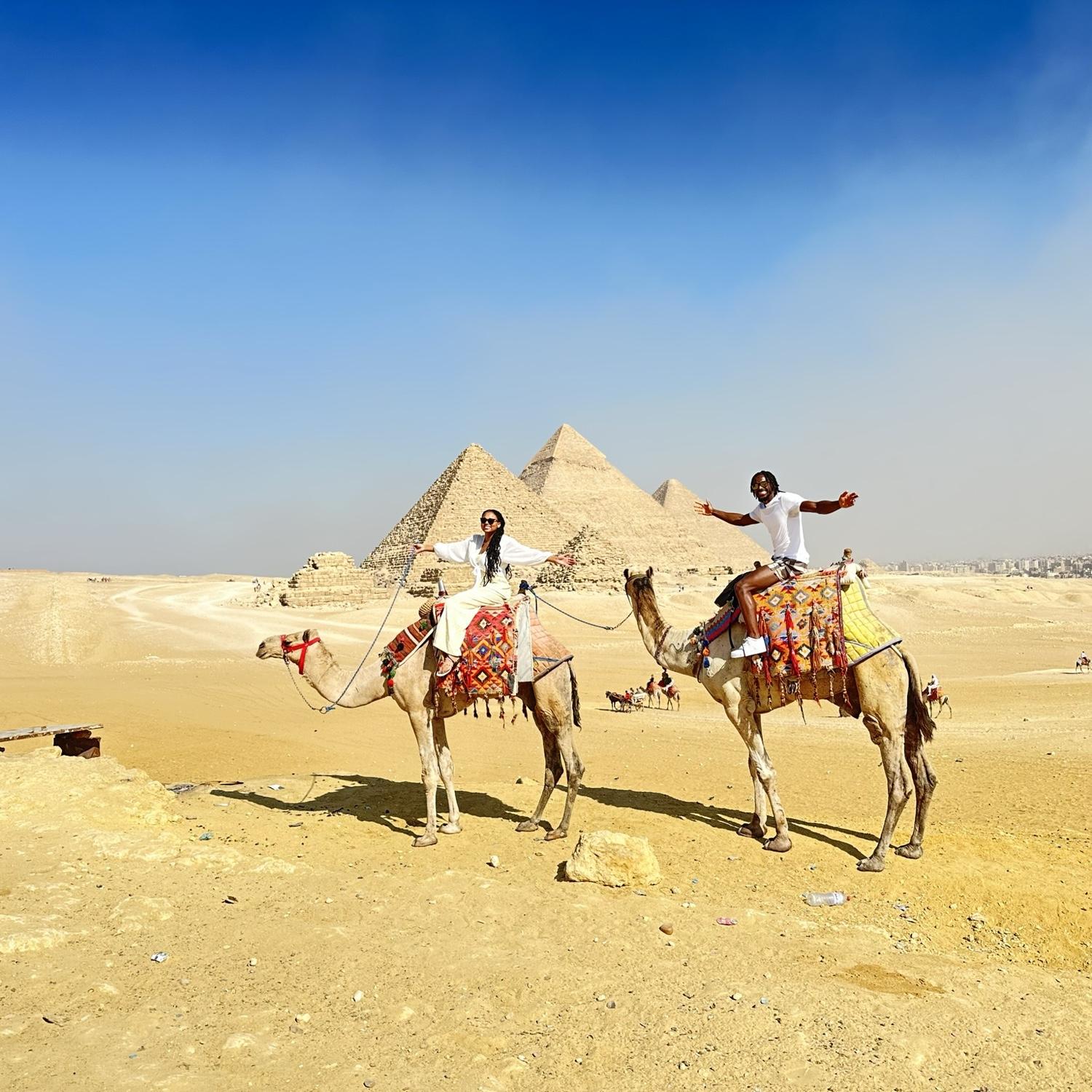 Visiting the pyramids on camels in Egypt