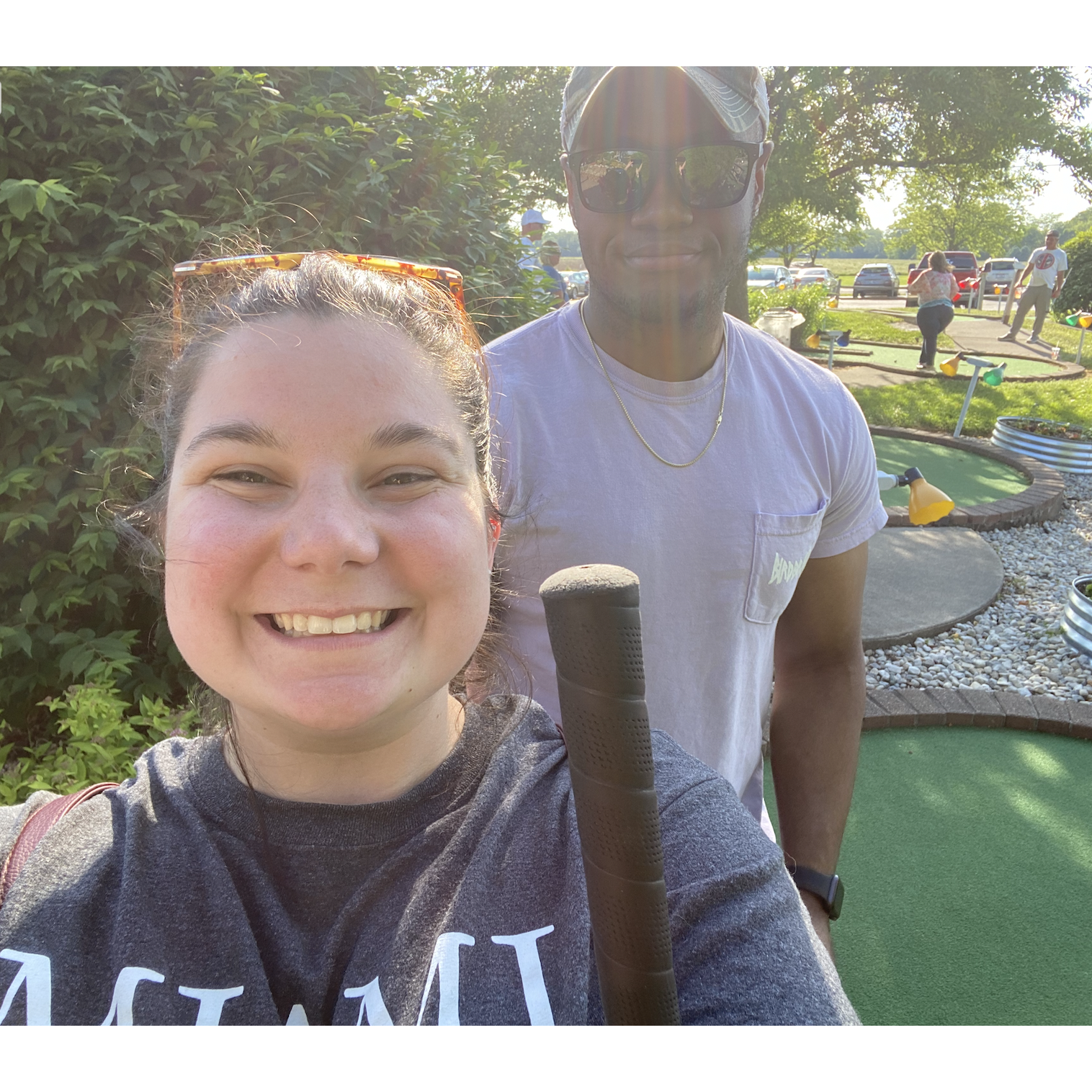 Competing in a game of putt-putt.