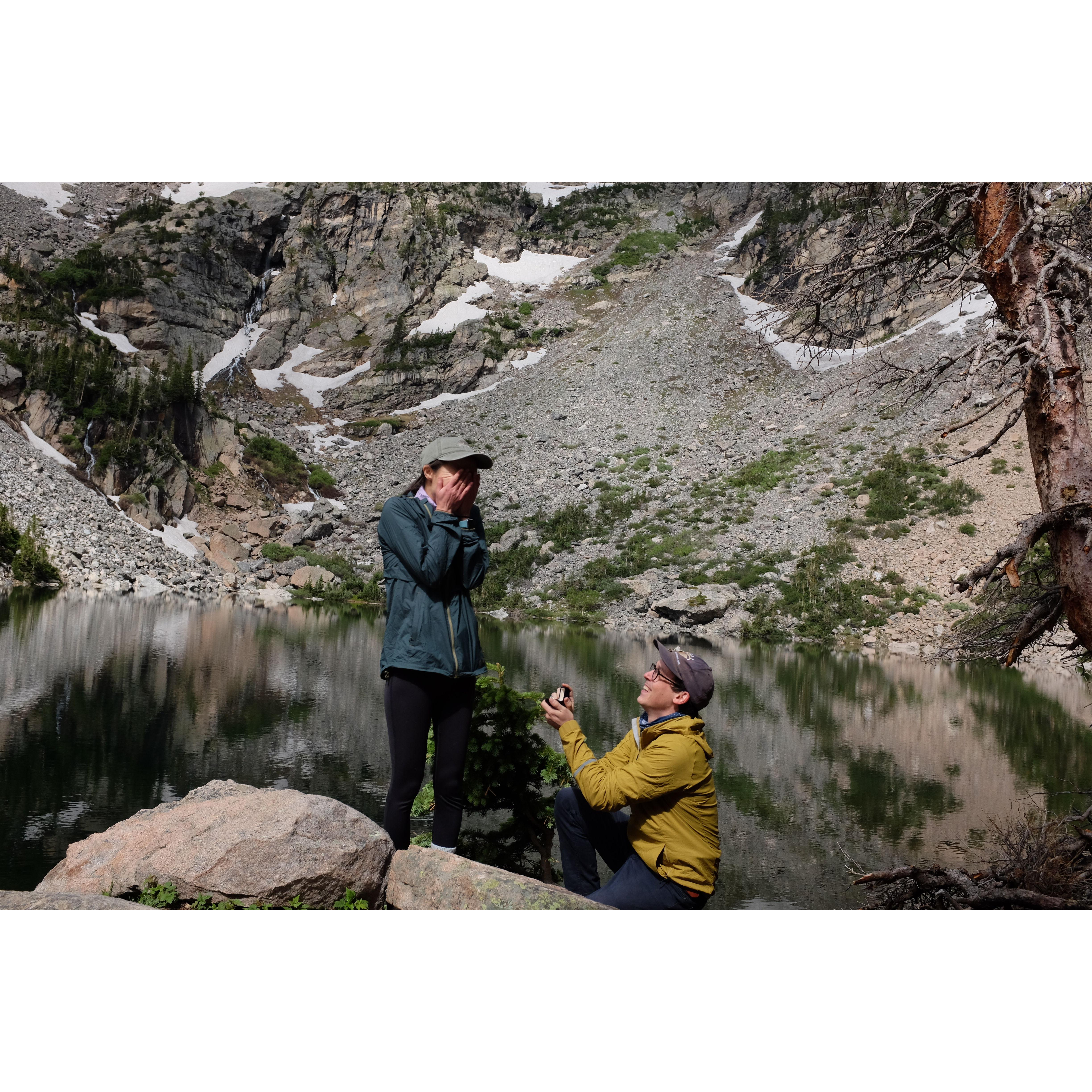 Proposal at Emerald Lake in Rocky Mountain National Park. Alex nervously set up a stack of cameras on timers to try to discretely capture this moment, yet somehow only this one photo came out okay!