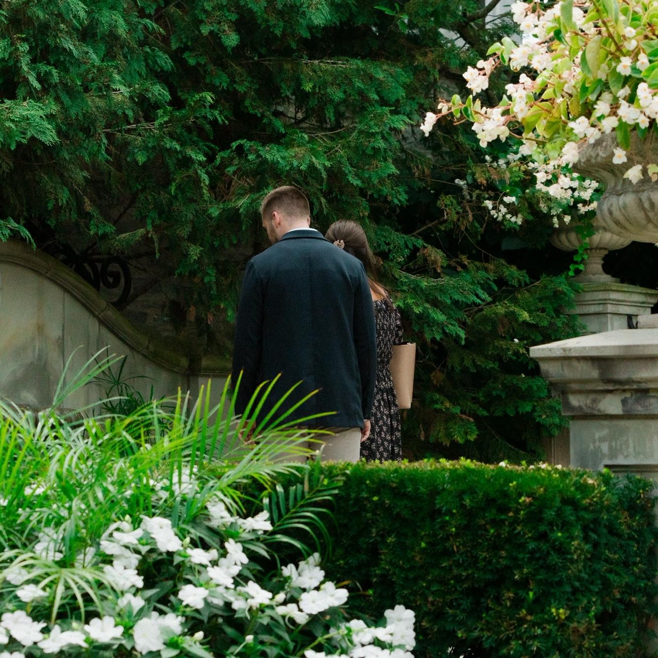 Duncan nervously leading Ashleigh to the private proposal area at Franklin Park Conservatory