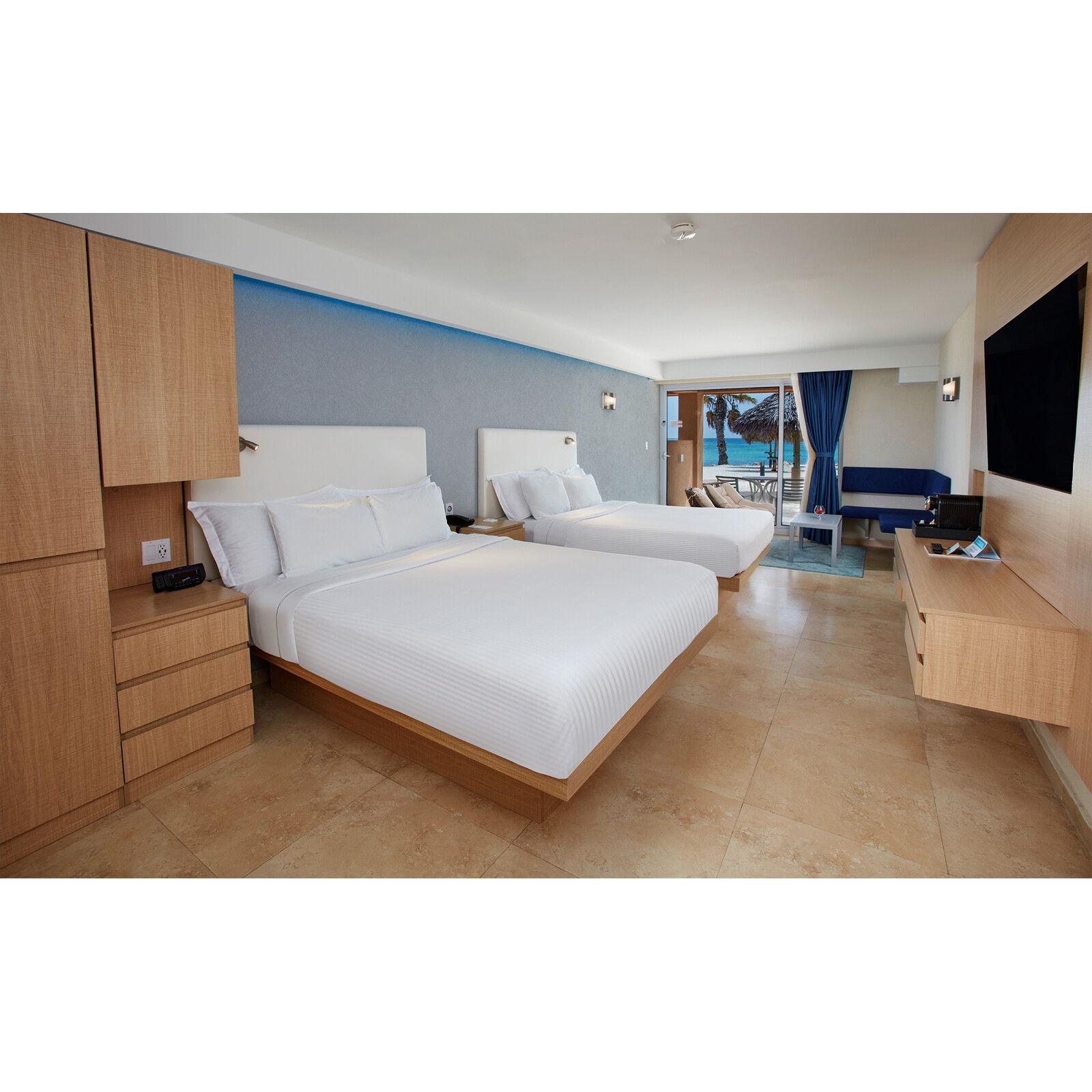 TAMARIJN Deluxe Ocean Front: Direct ocean view. The sand, sea, and shore await outside your oceanfront patio or balcony. King rooms offer a sofa bed (2 adults, 2 kids) or double queen rooms.