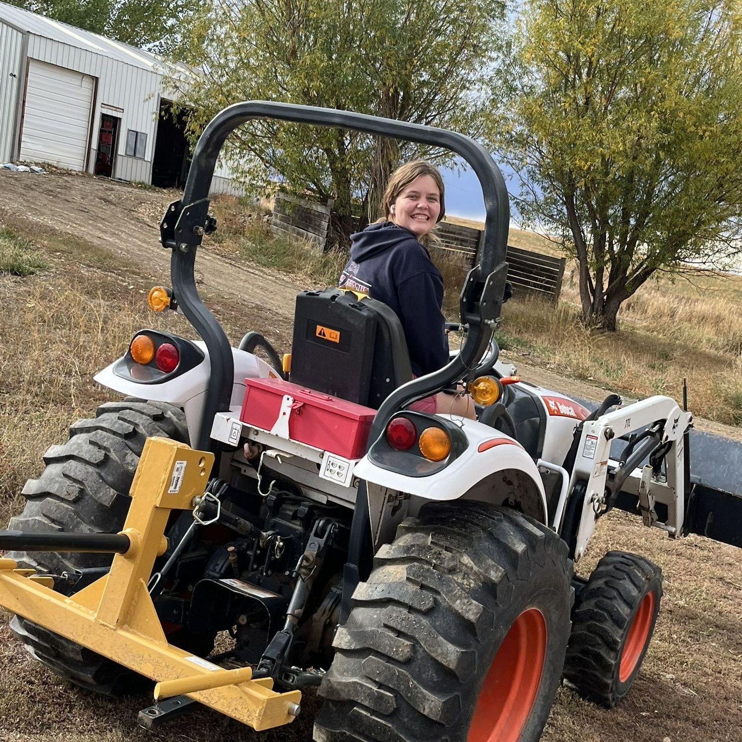 Kinsley on the tractor.