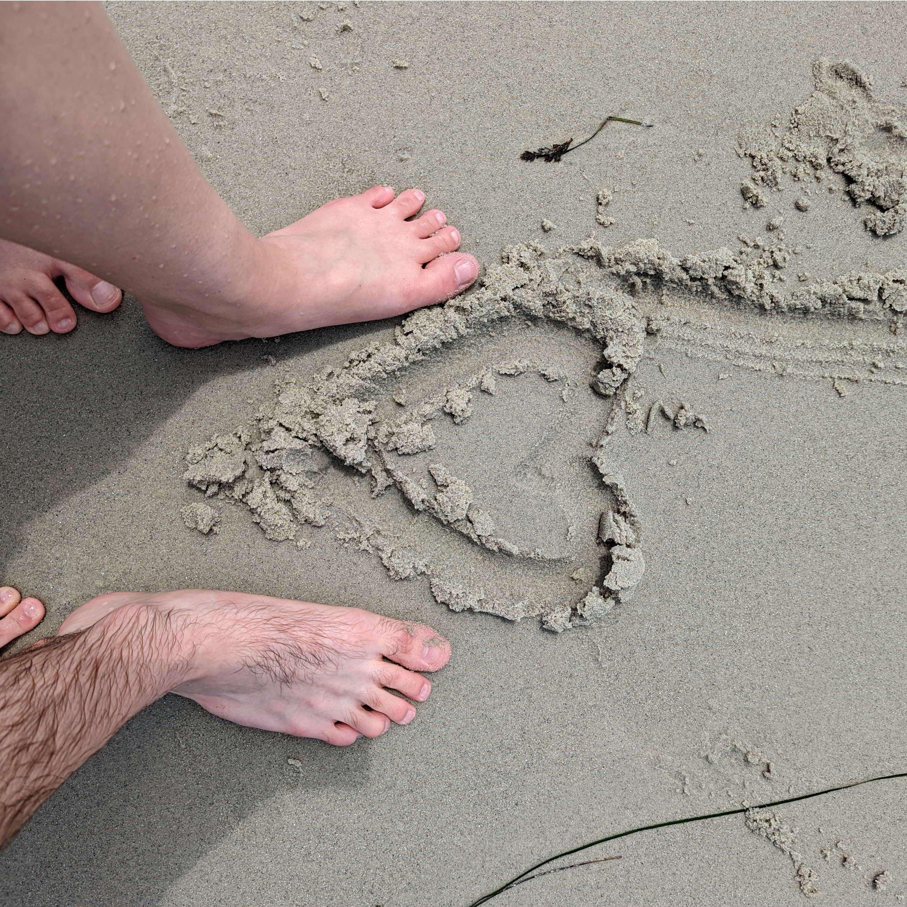 Because no engagement photo album would be complete without a cheesy heart-in-the-sand photo!