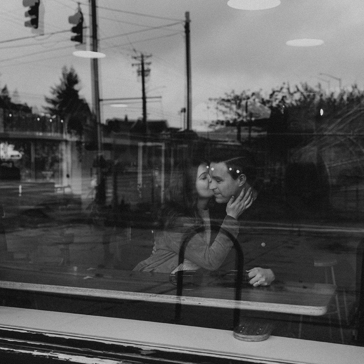 Engagement photos by In the Alpenglow at Bluebeard Coffee Roasters on a rainy day in Tacoma, Wahington in the fall of 2023.