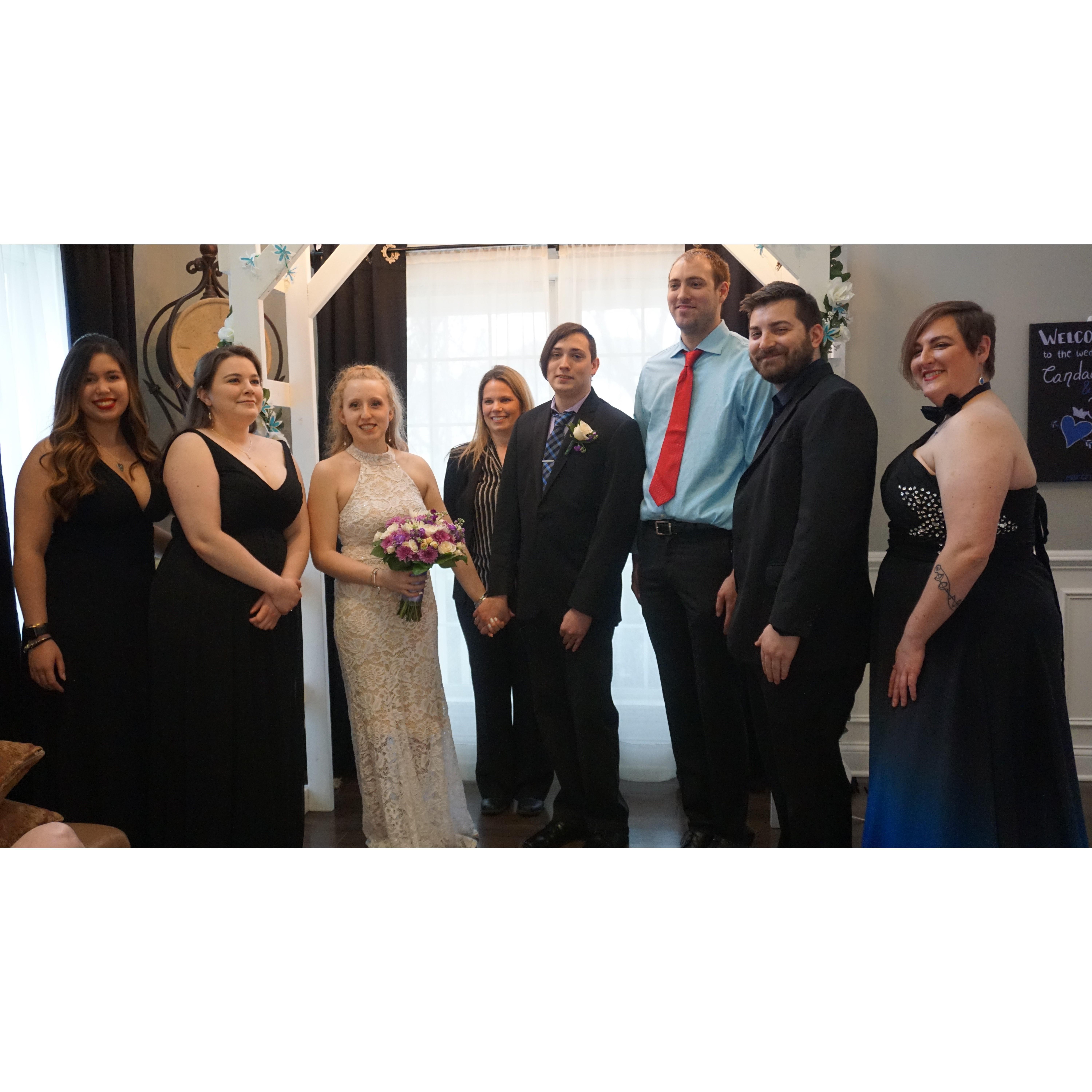 The wedding party (minus a groomsman) and officiant