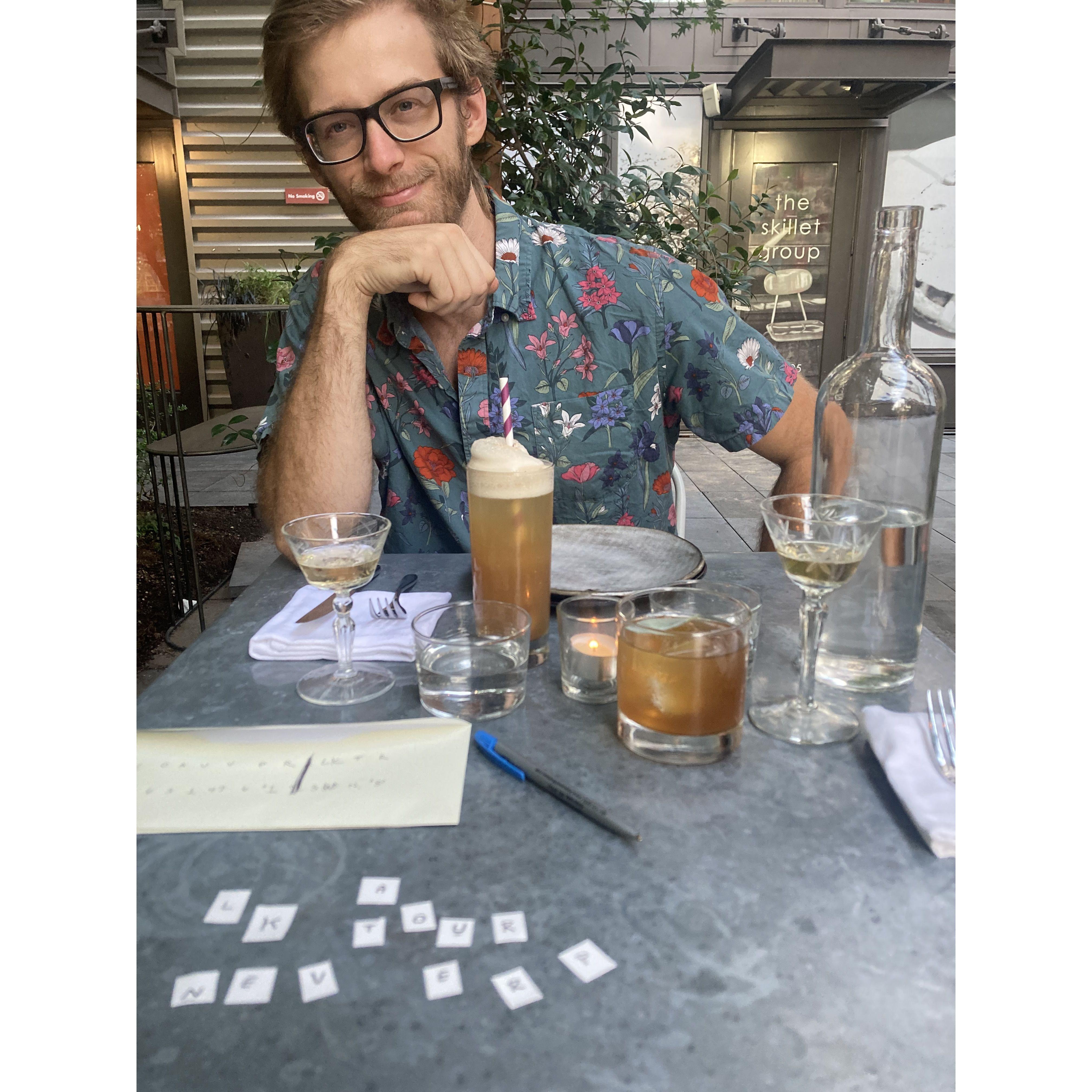 Charlie watches Amber decode the final clue of our engagement scavenger hunt!